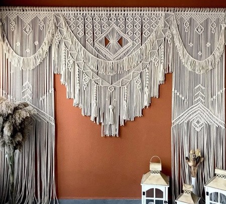 Large handmade macrame wall hanging with layered fringe and detailed knot work