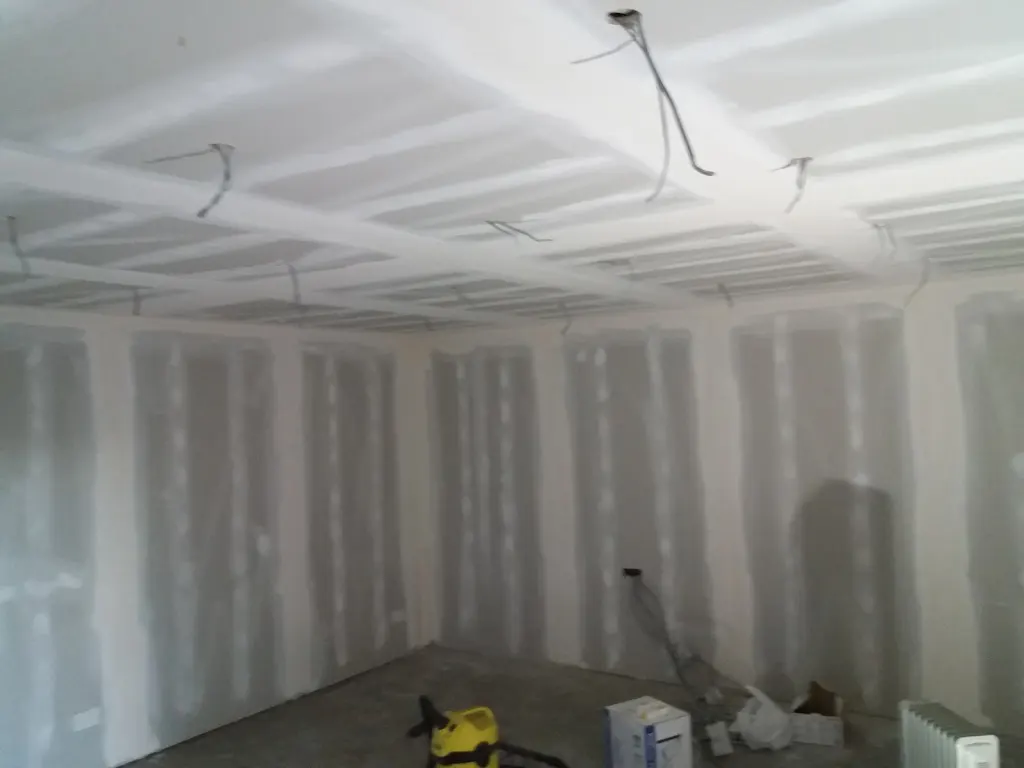 A room with ames taping and some material on the floor