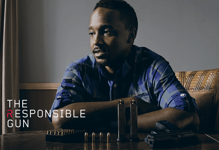 A man with dark skin and short hair sits with his arms resting on a table, looking off to his left. He wears a blue and black plaid shirt. Beside him on the table are several bullets and two handguns. The background is a plain light gray wall. To the left of the man, the words “THE RESPONSIBLE GUN” are written in white text.