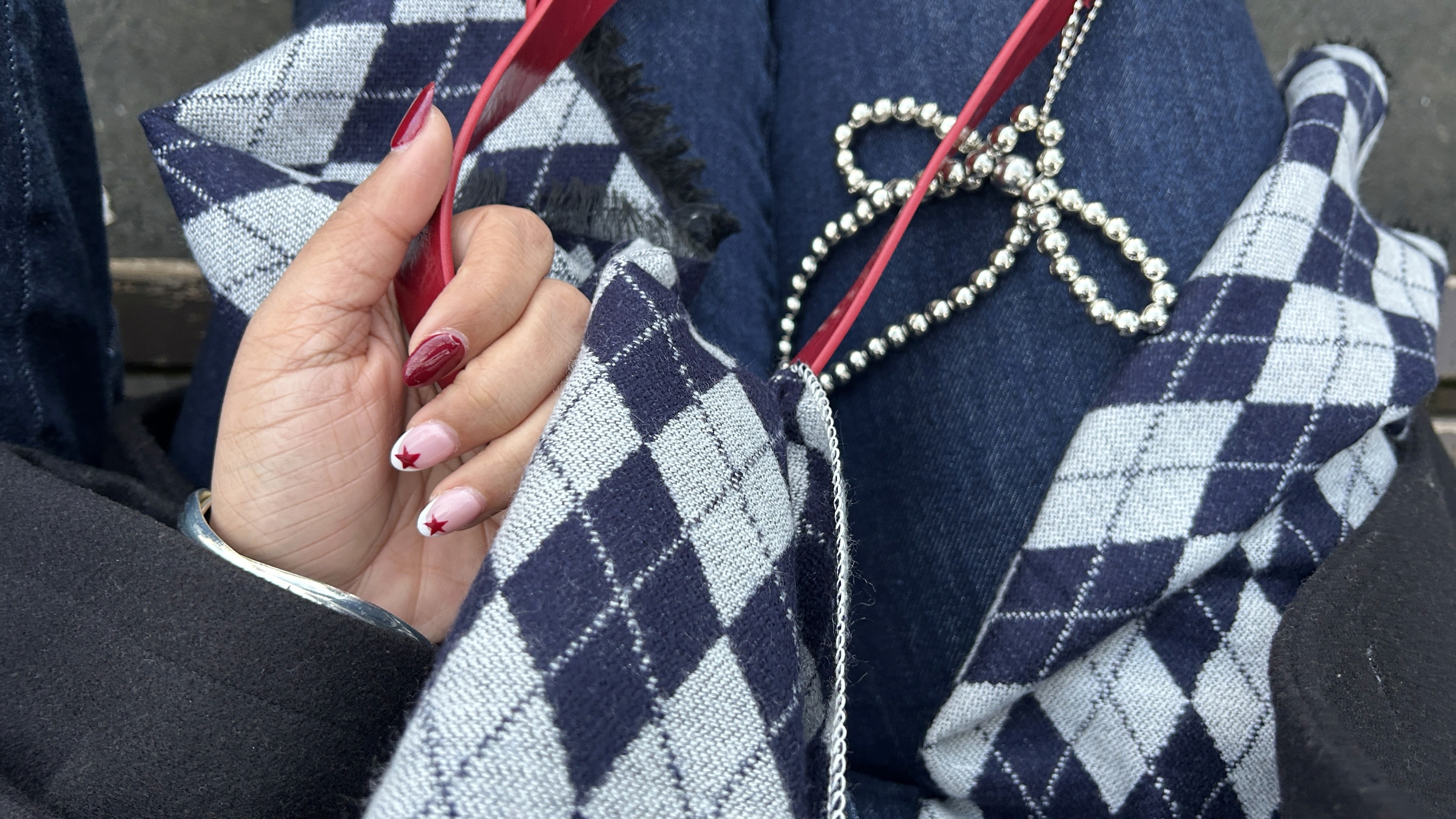Close-up of a yellow tennis ball sitting on a green court, positioned near the white center line.