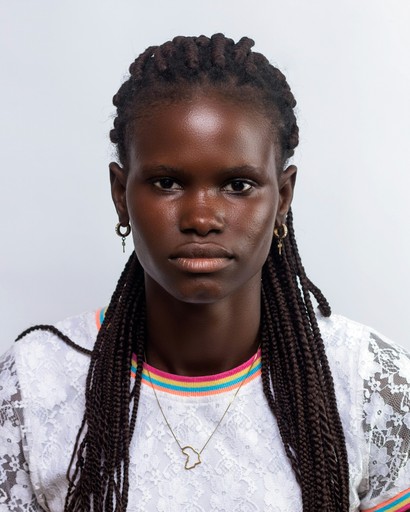 a woman with braids and a white shirt