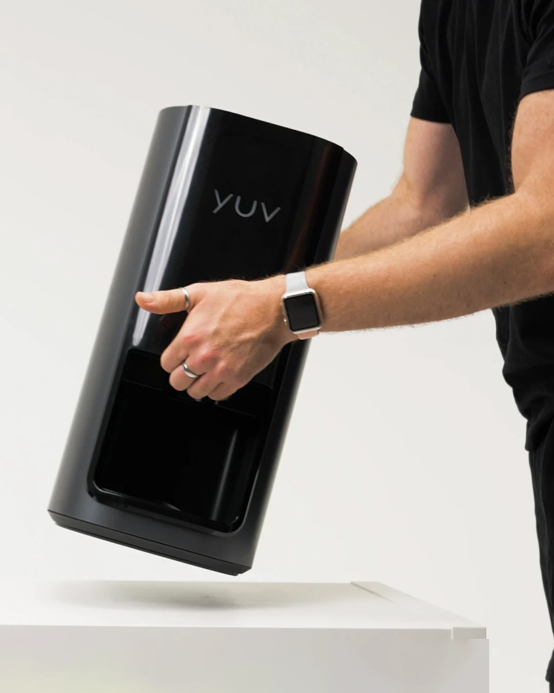 A person carrying the yuv® Lab and placing it on a table.
