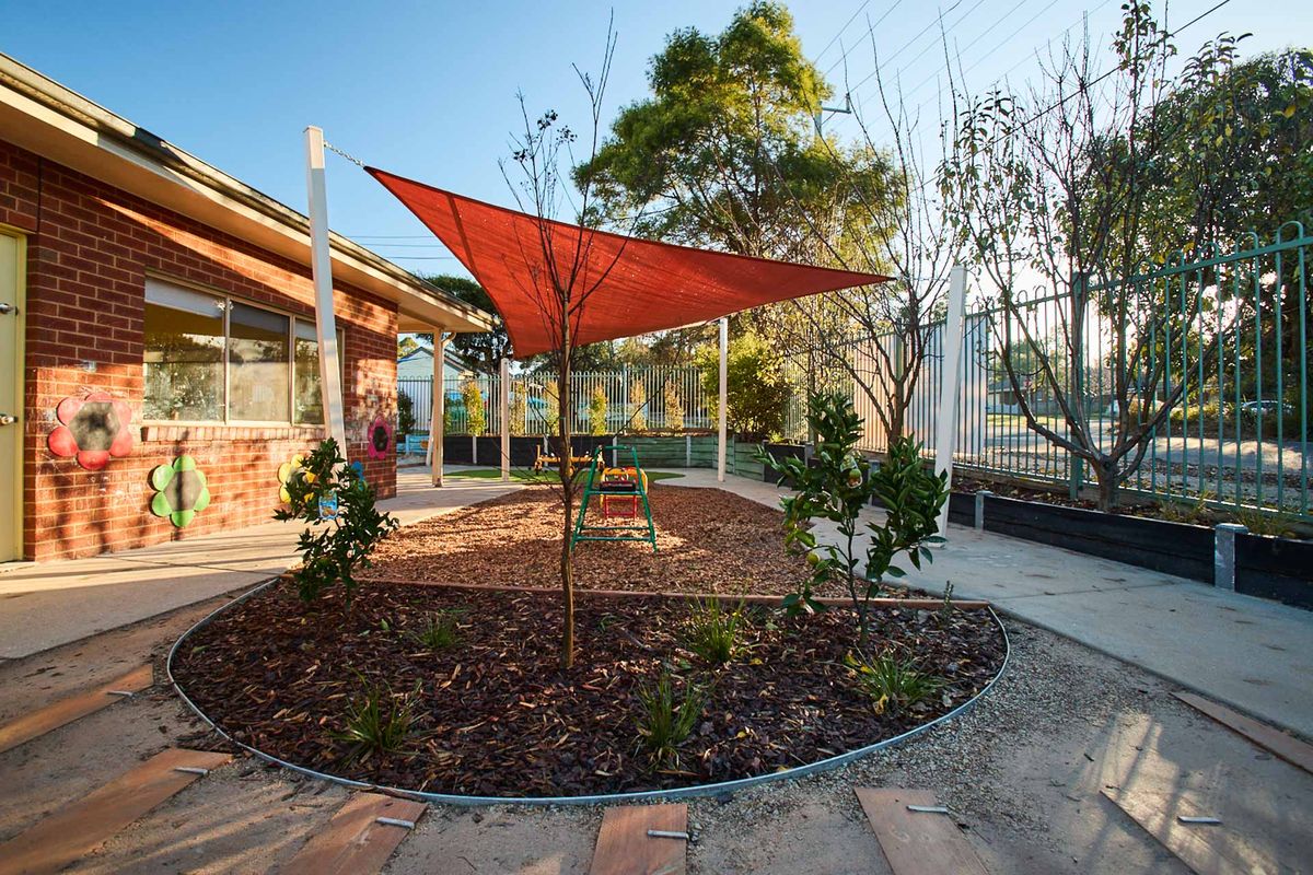 Luxurious modern interior with a sculptural art piece, floating books, a sleek marble bench, ambient lighting, and a gold metal partition