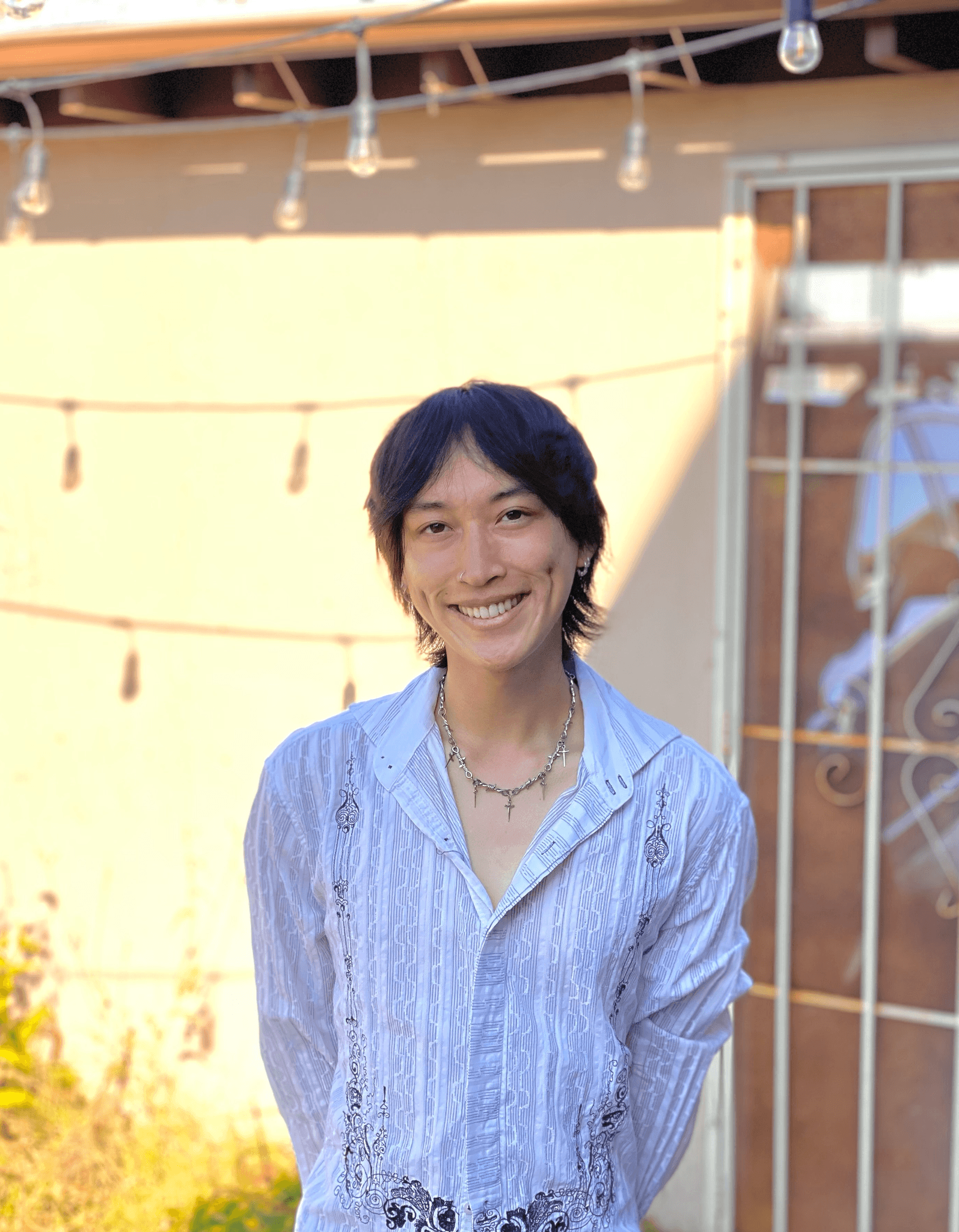 Kaiwen standing in his backyard smiling