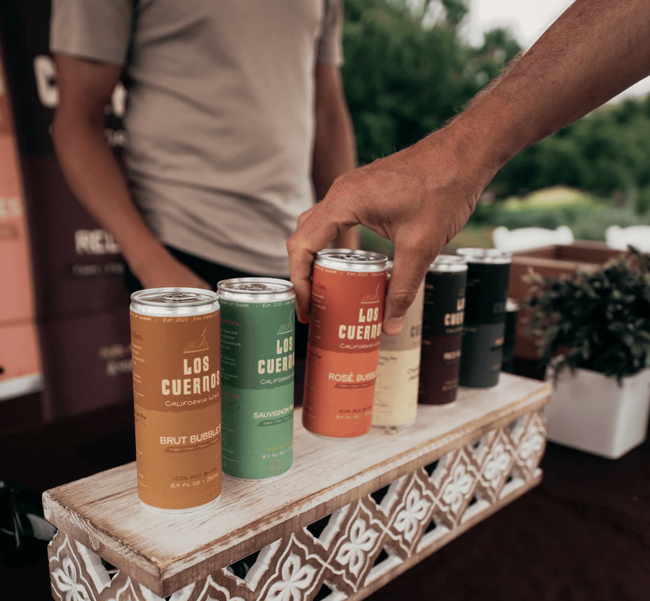 Hand grabbing a can containing aged wine