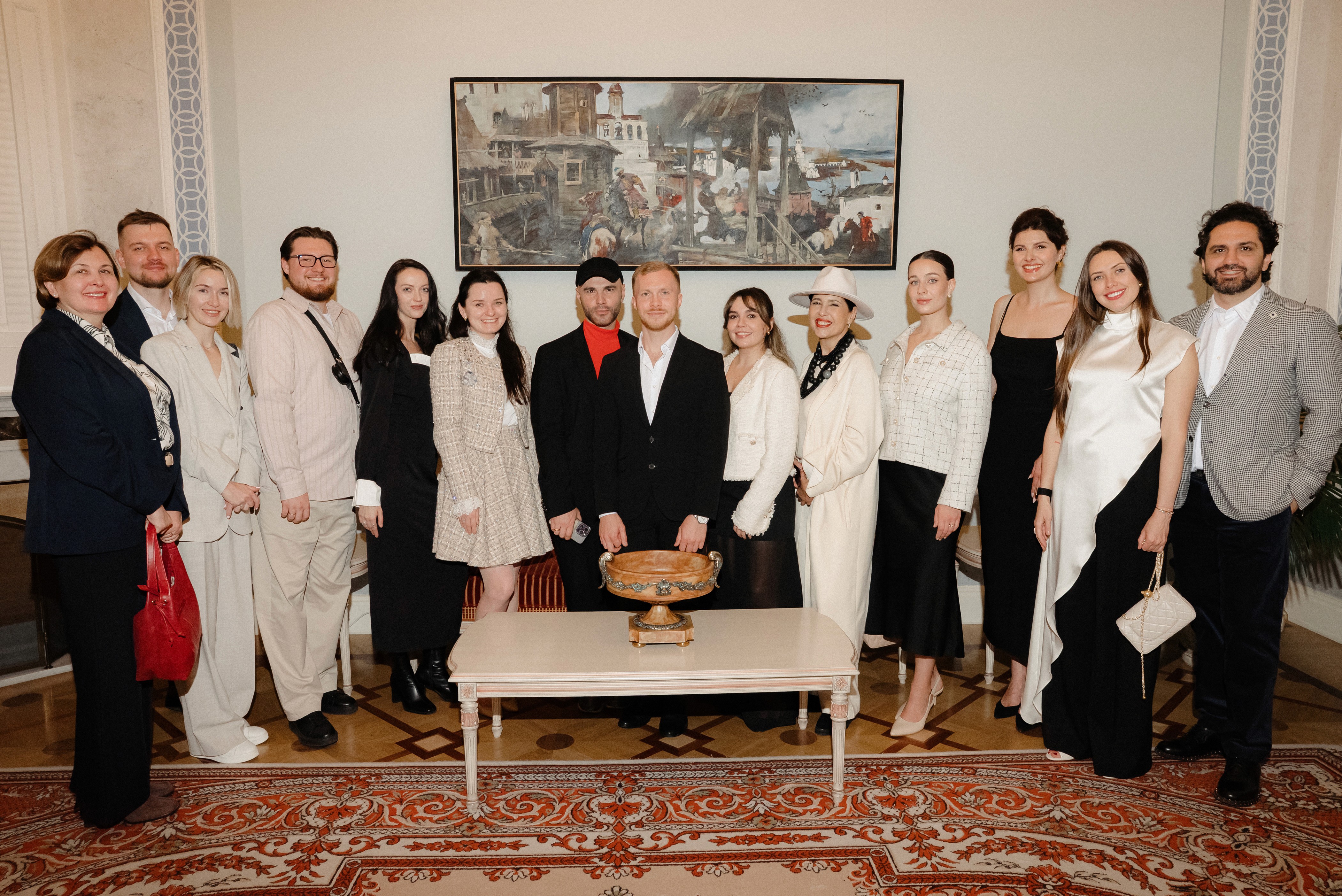 A woman observes framed black-and-white photographs in warm golden light