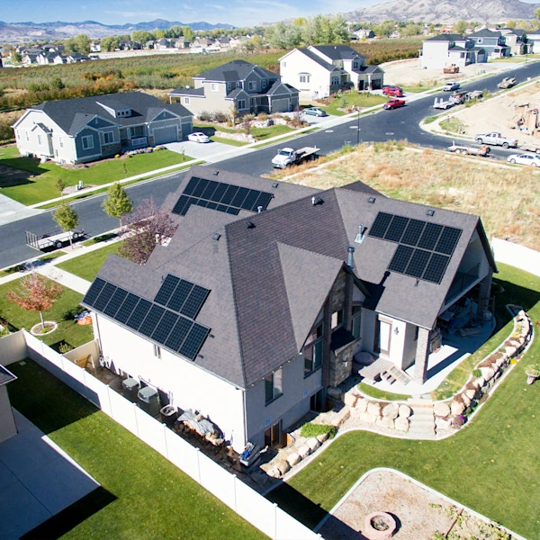 Sun glistening over a lush green landscape and solar panels