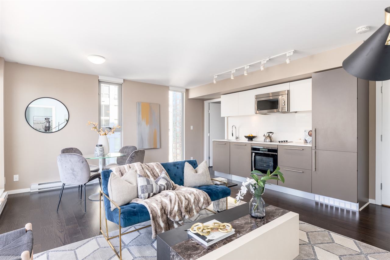 Modern living room featuring a cozy sofa, stylish chairs, and large windows, creating a bright and airy space.