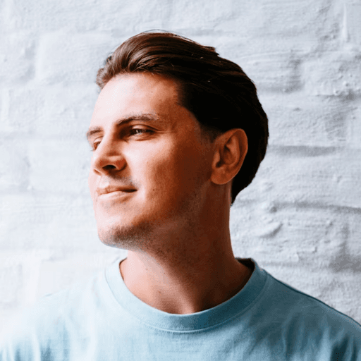 man wearing eyeglasses and blue shirt inside coffee shop