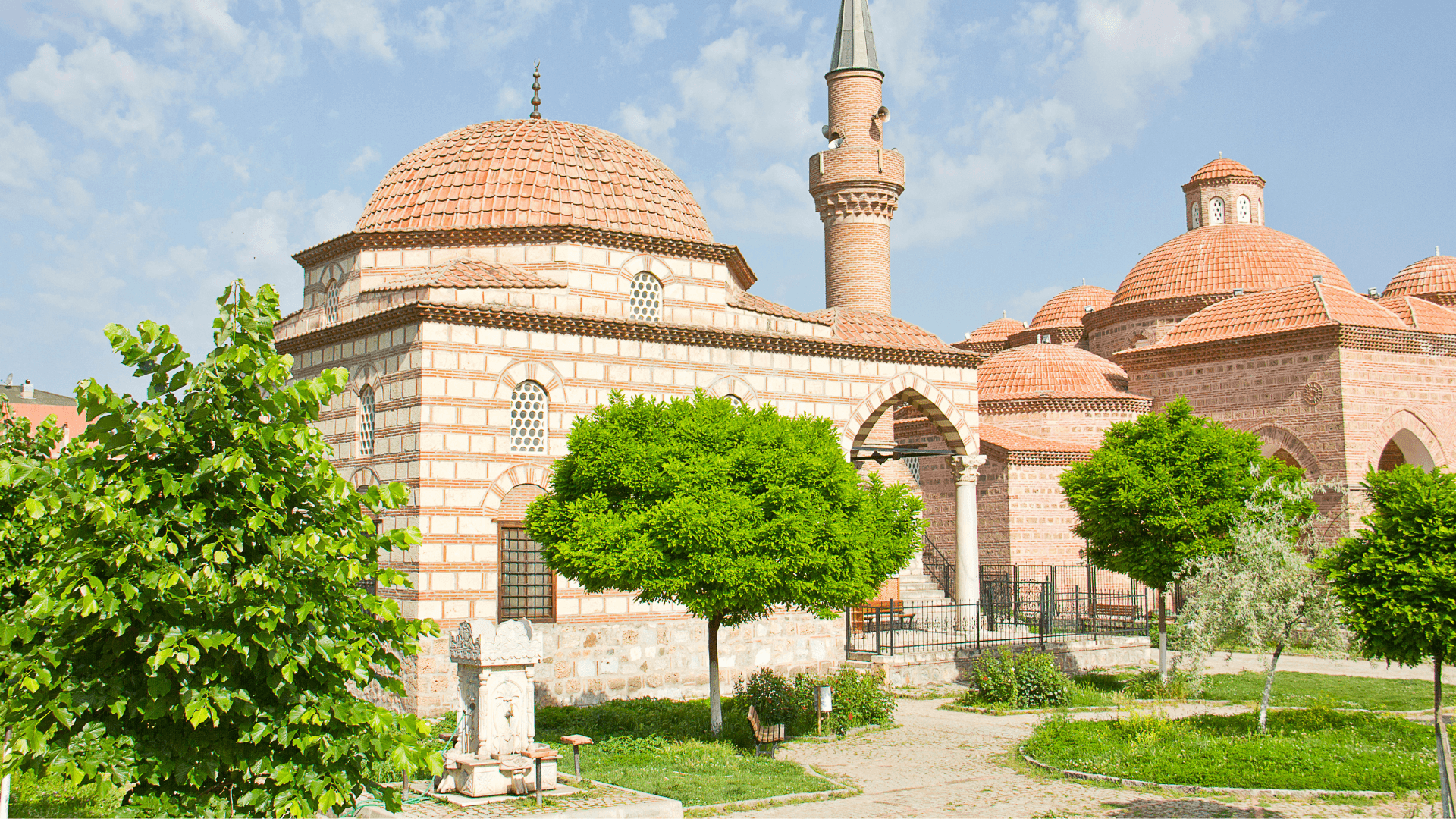 Historic Muradiye Complex in Bursa featuring Ottoman domed architecture and landscaped imperial courtyard garden
