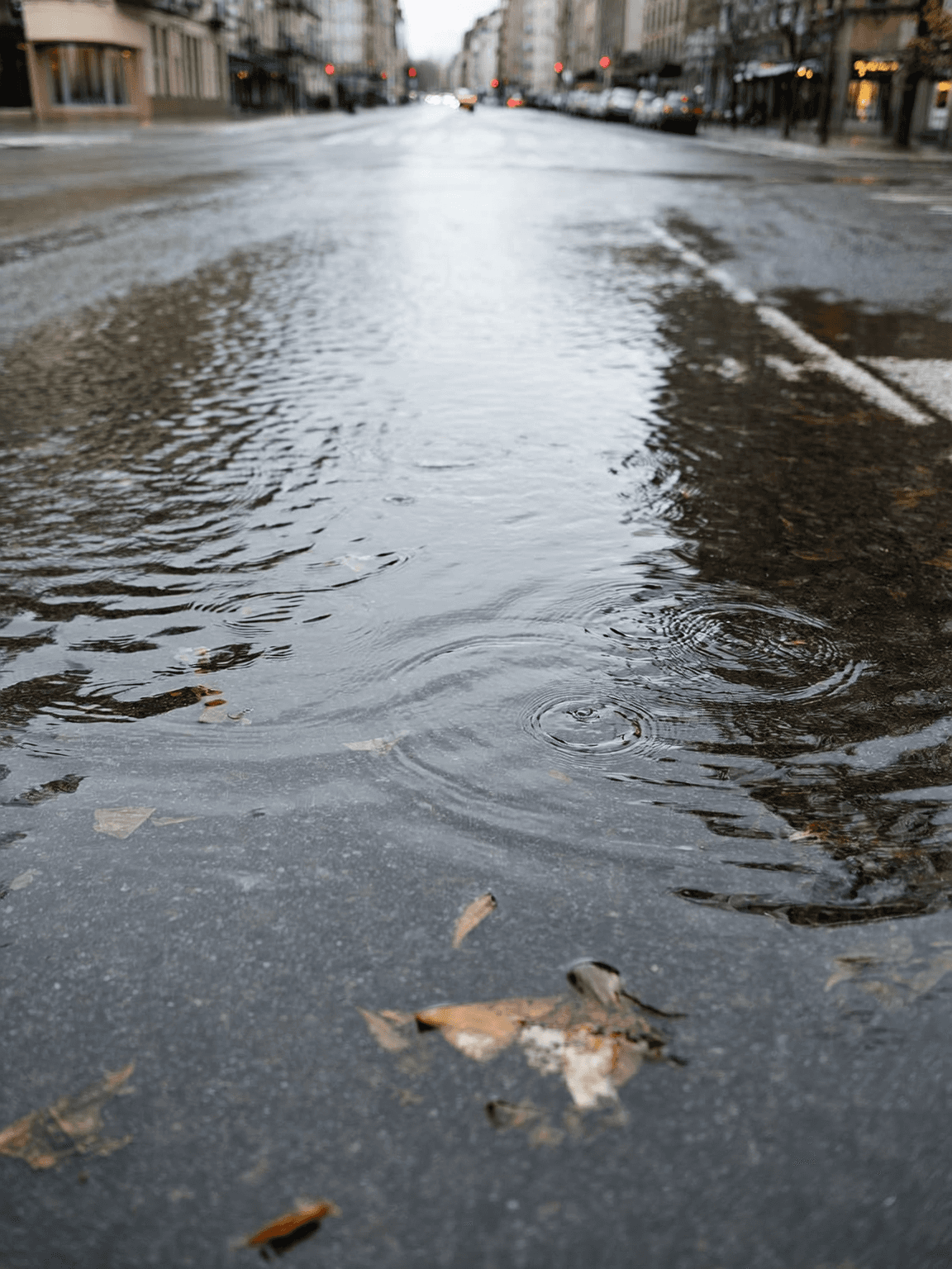 Smiling young woman with long hair standing against a dark green background, holding a finger to her chin.