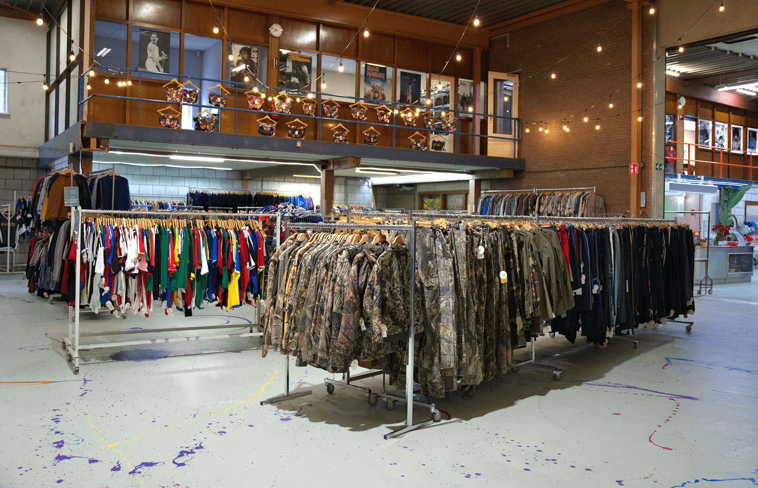 Clothing racks filled with garments in a large retail space.
