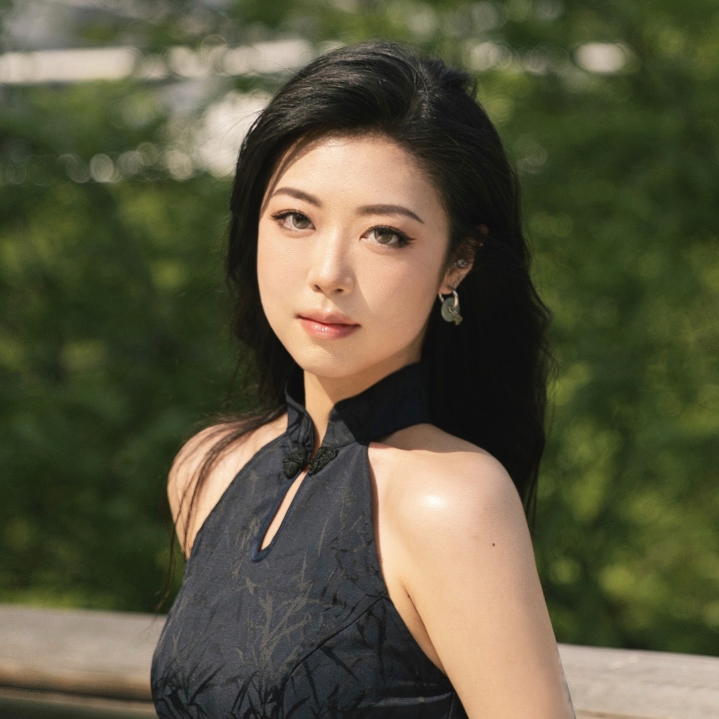 girl with long black hear wearing textured black halter top