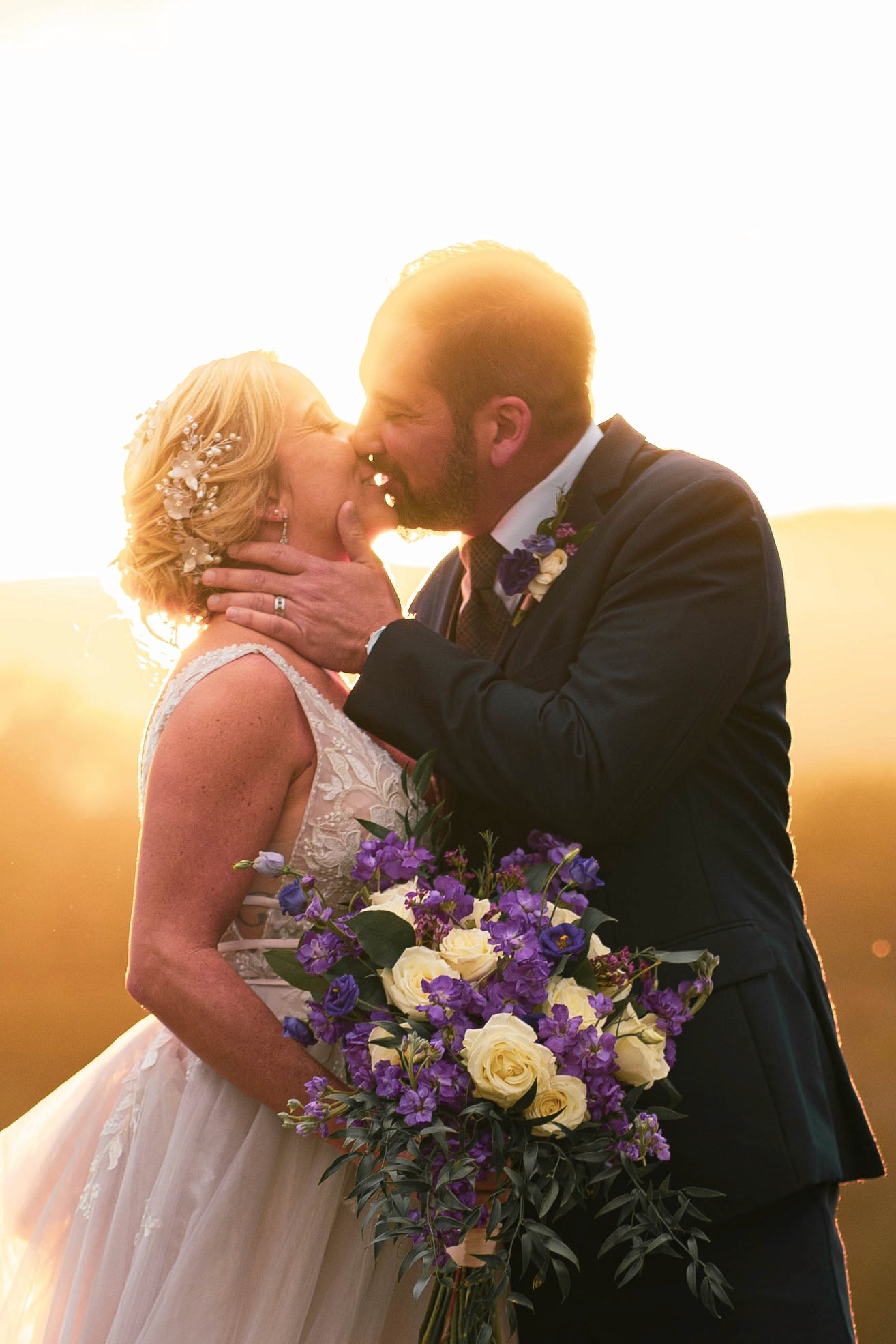 A beautifully decorated wedding cake featuring red and white roses.