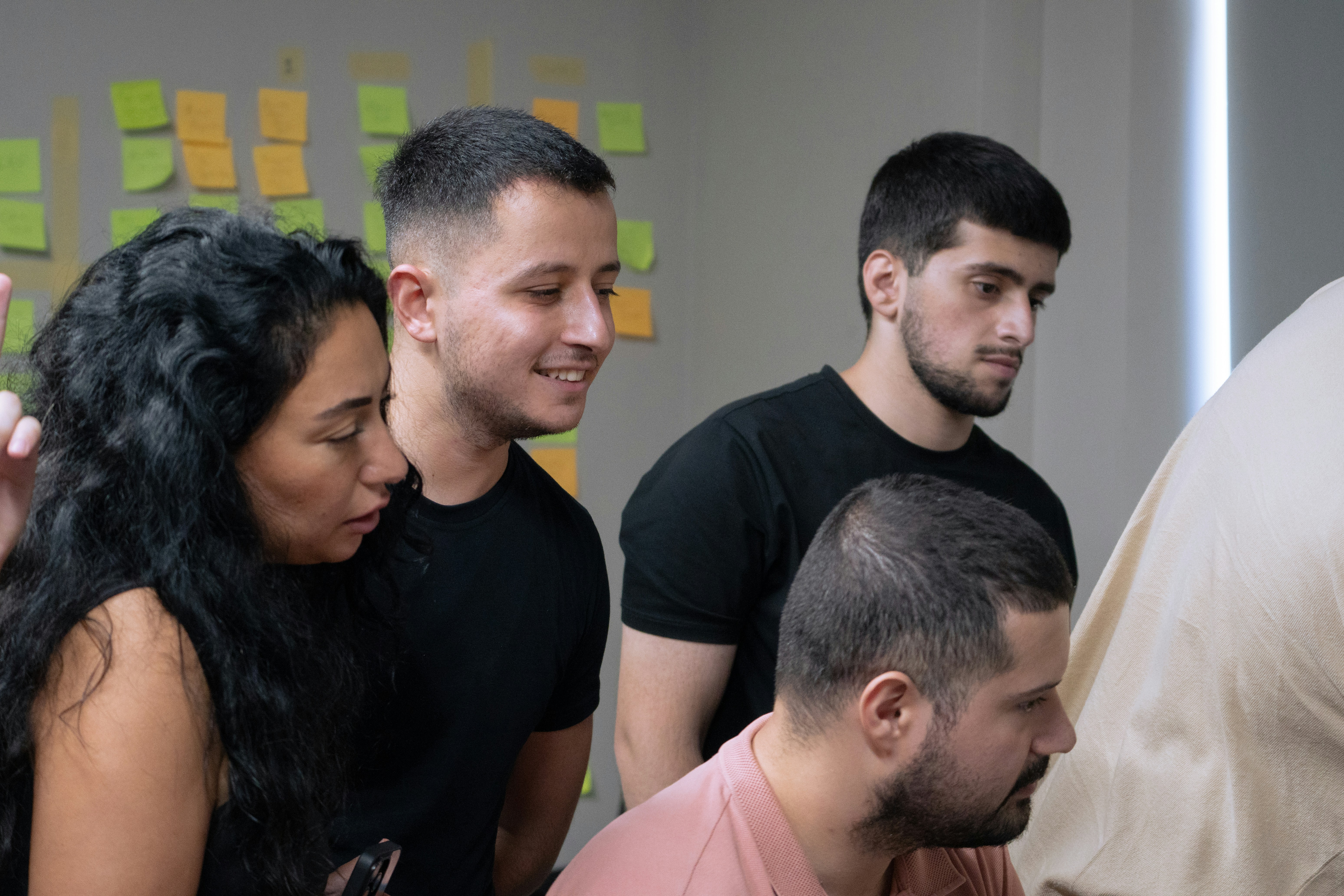 A group of people looking at a computer screen