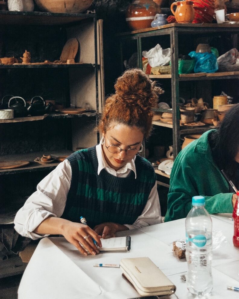 Workshop participant writing at a table.