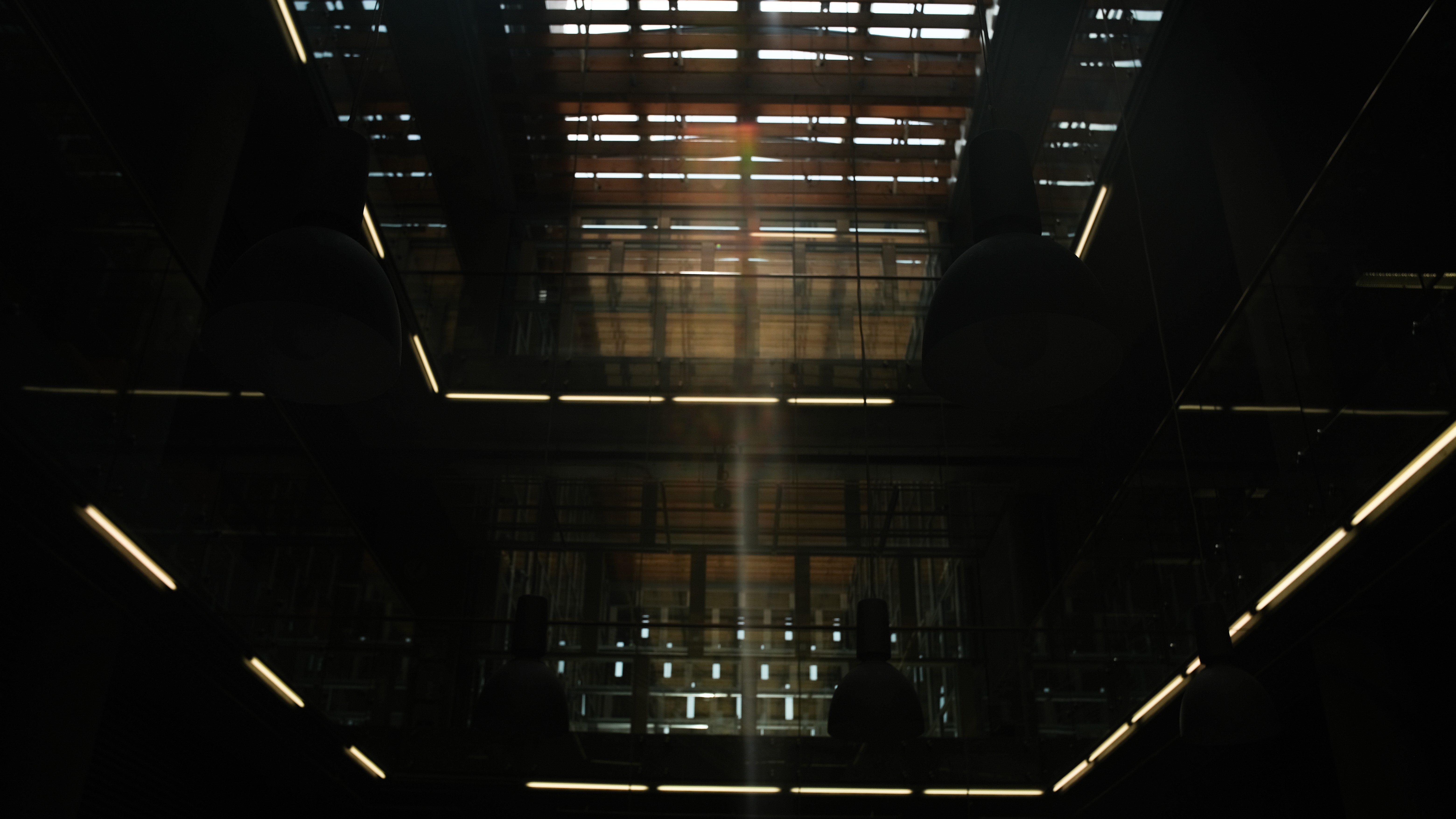 Two people talking on a rooftop at sunset