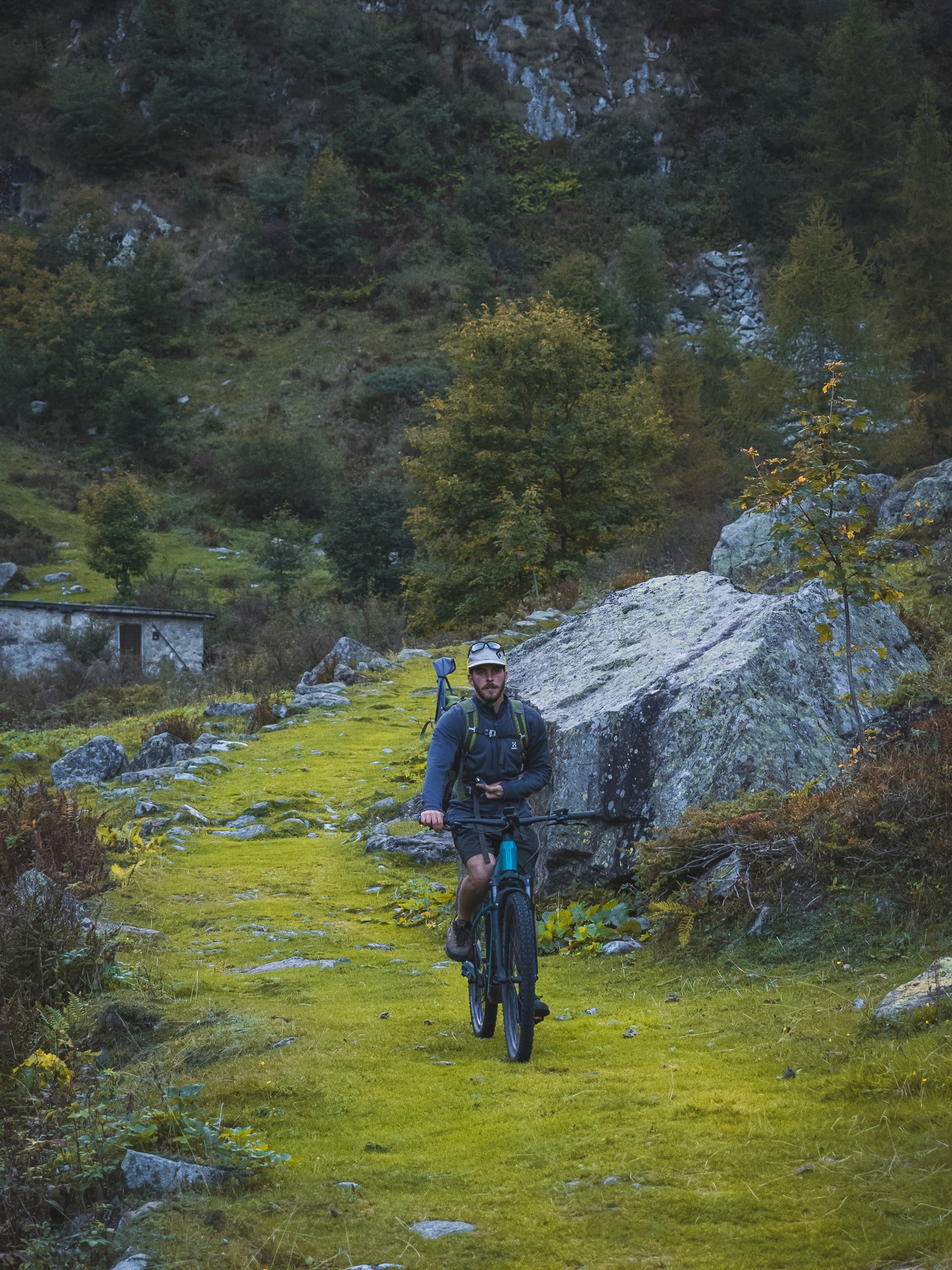 Mountain biker with fly rod in the Dolomites