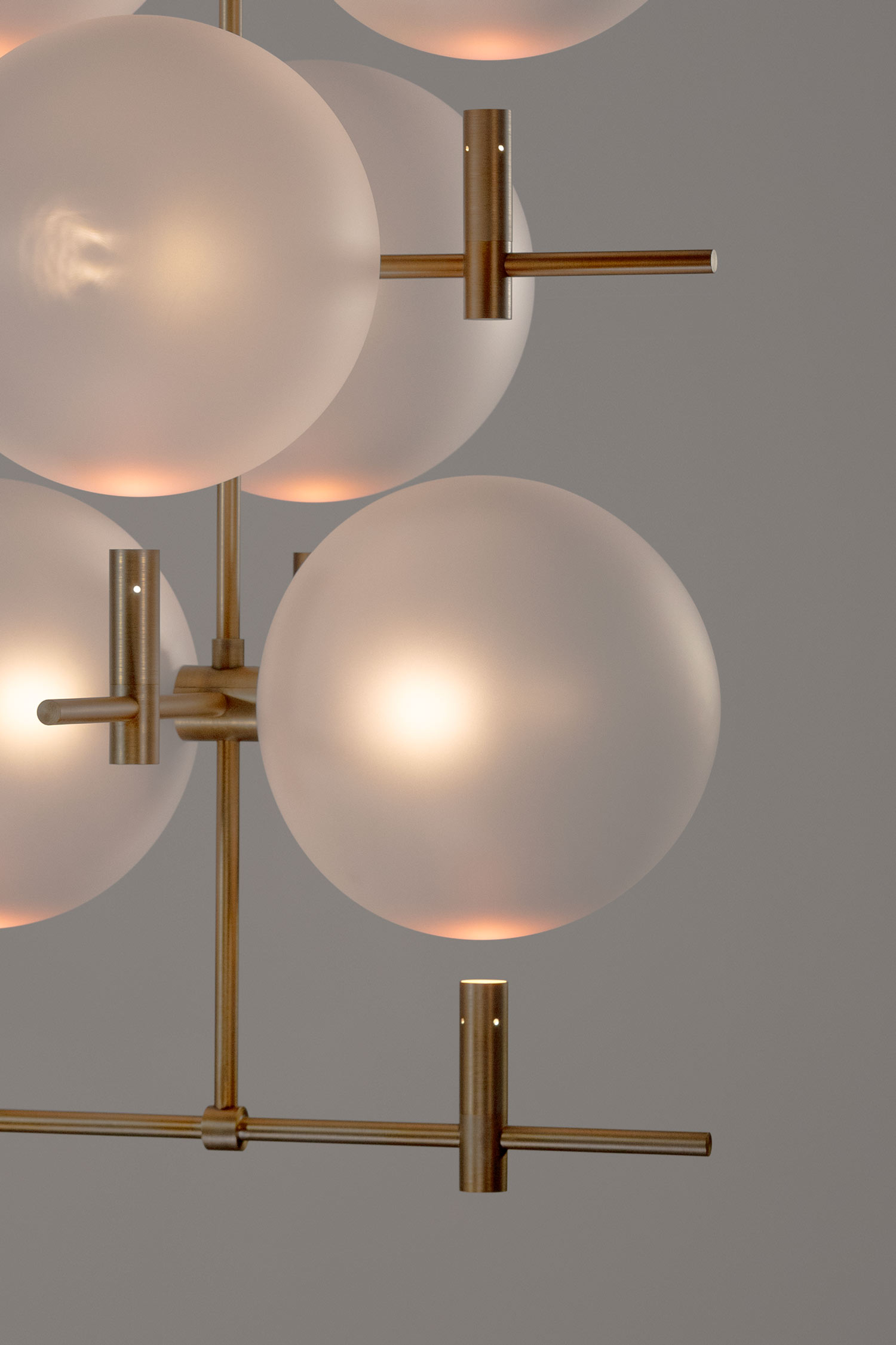 Close-up of vertical luminaire frame revealing sculptural structural rhythm in metal by Jiri Krejcirik