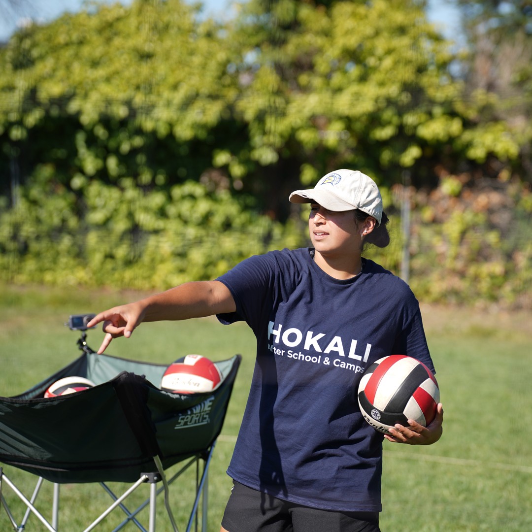 HOKALI educator teaching proper volleyball techniques to elementary students