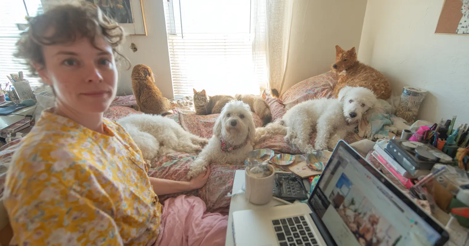 A dog resting beside a remote worker’s desk