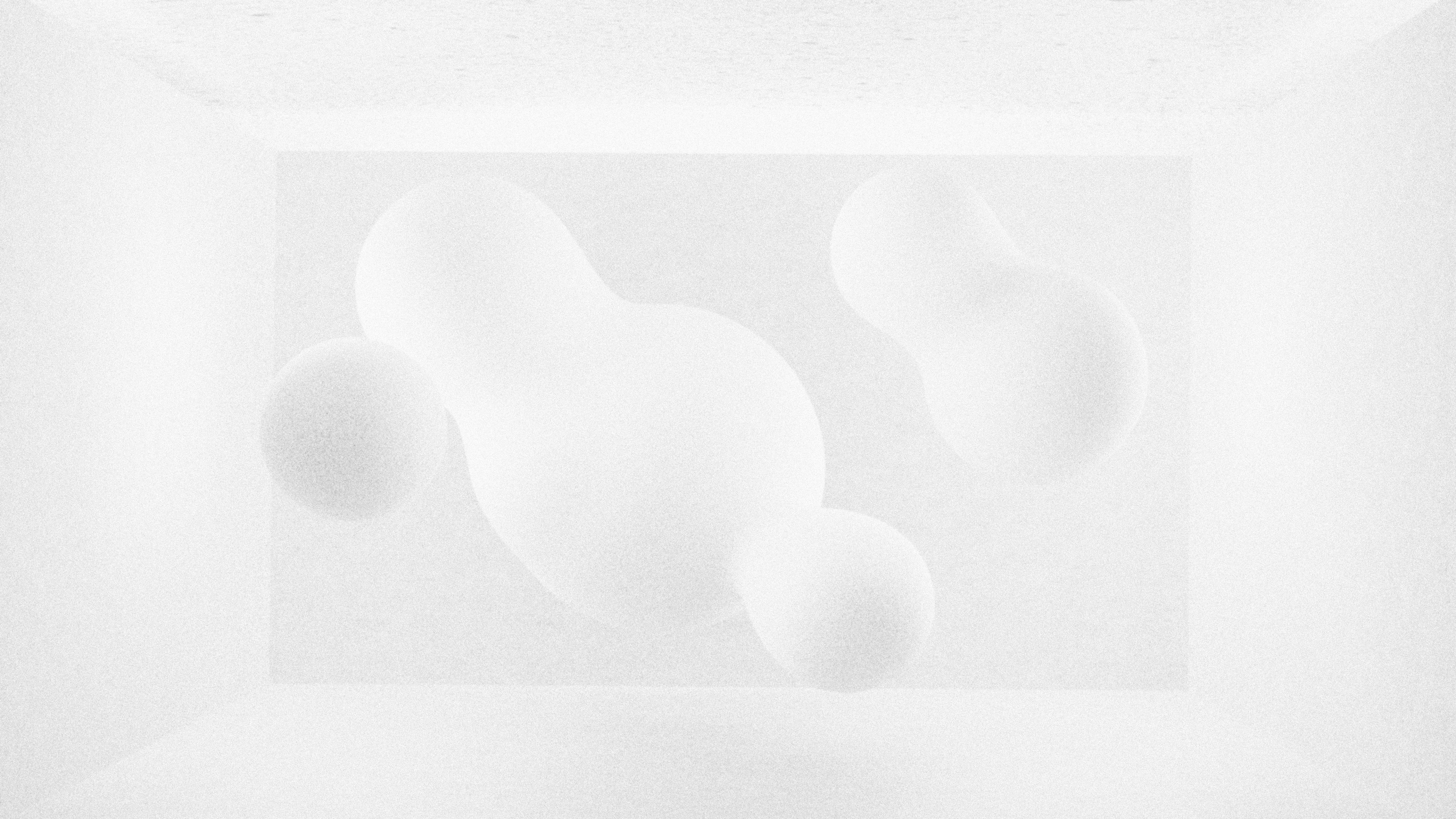 a black and white photo of a vase with three balls in it