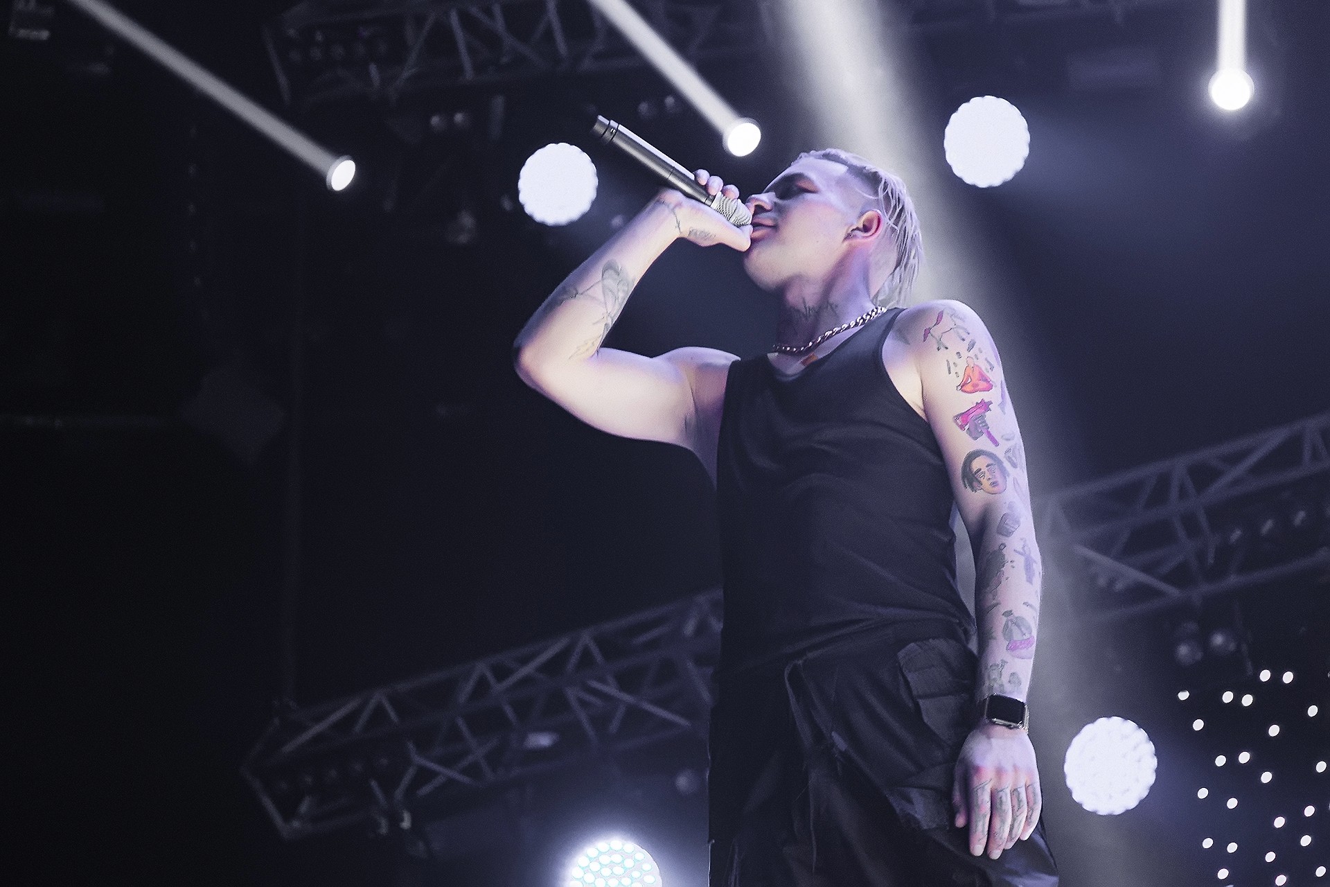 Full moon rising over a dark, silhouetted mountain ridge.