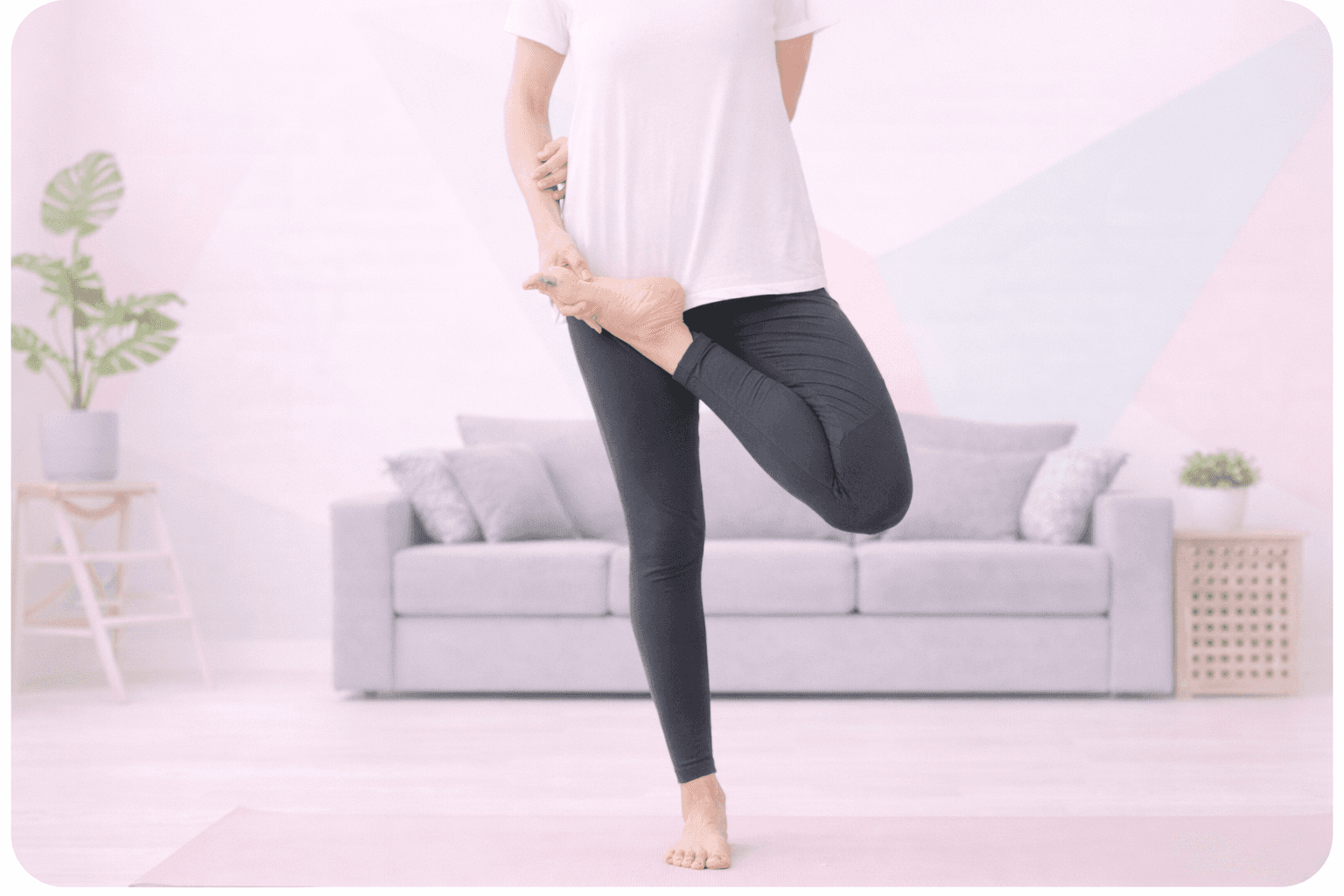 Woman practicing yoga tree pose on mat indoors.