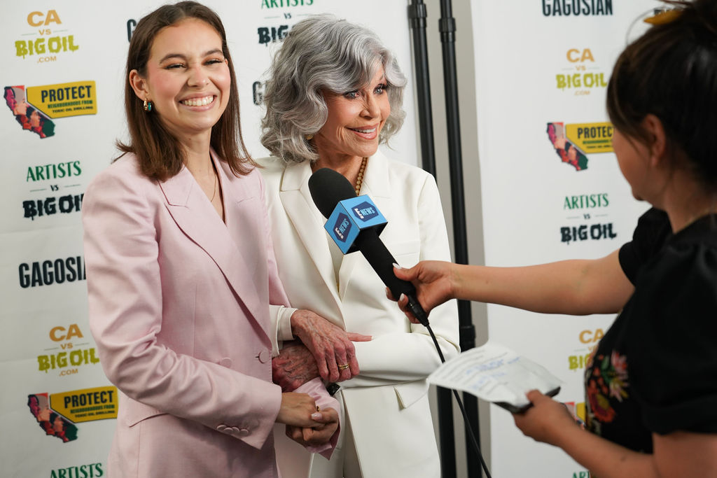 Activist Nalleli Cobo and Activist and Actor Jane Fonda being interviewed at an event.
