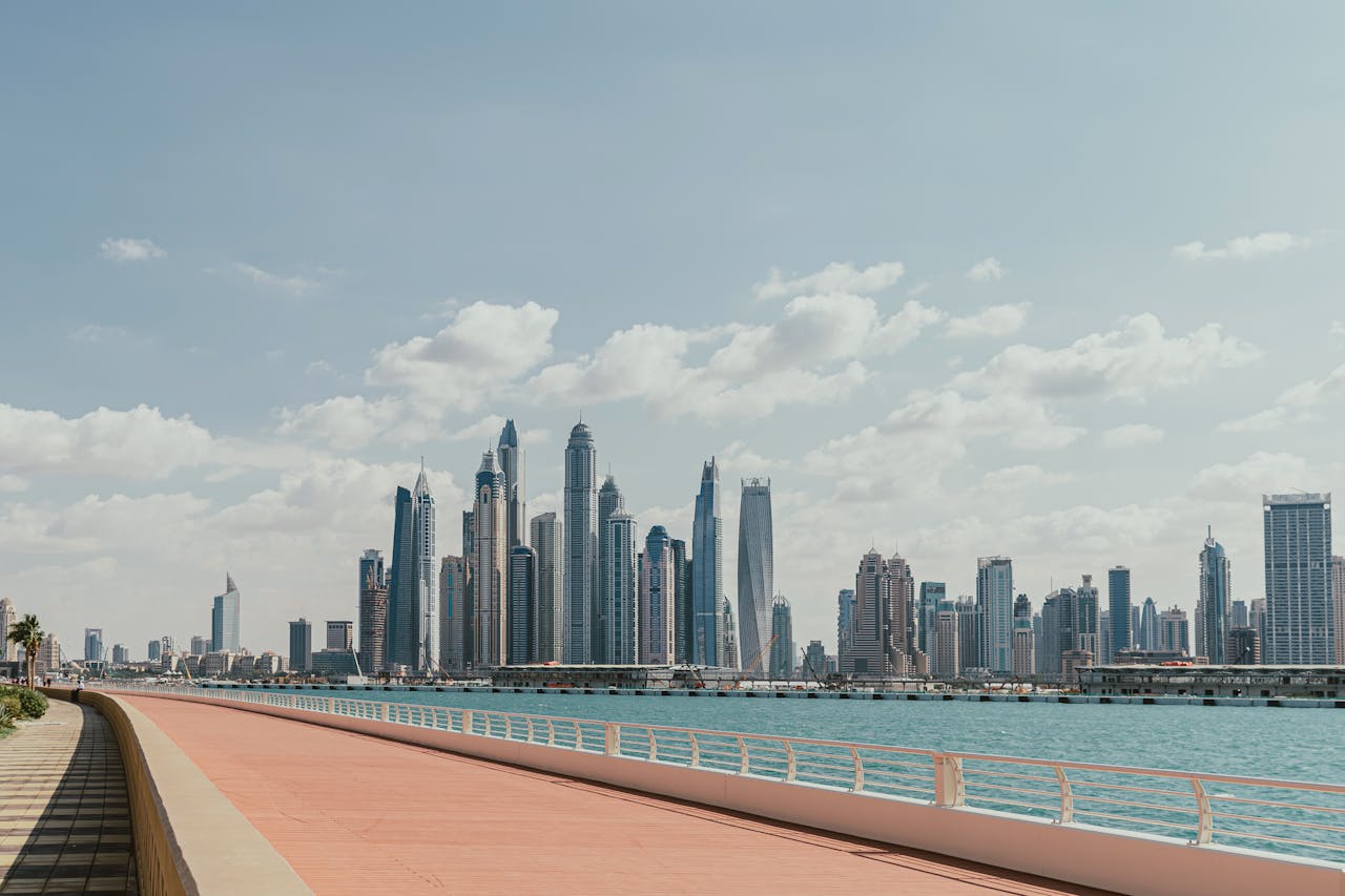 A waterfront promenade with a clear view of the Dubai Marina