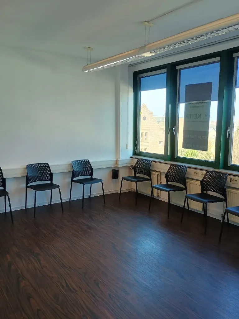Modern office reception area with wooden paneling and waiting area.