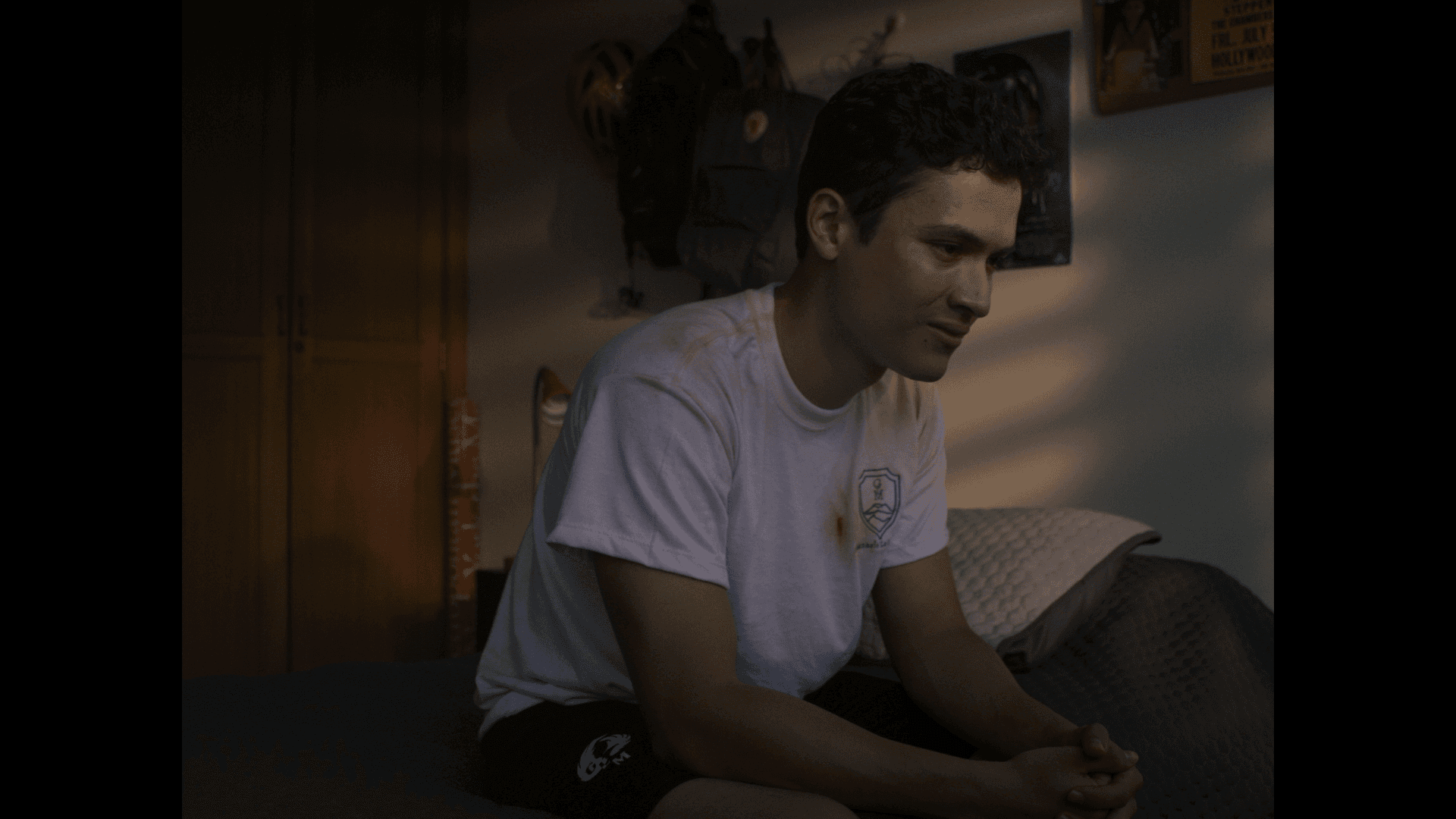 View of the French countryside through a stone villa’s open living room, with sofas and trees framing the scene