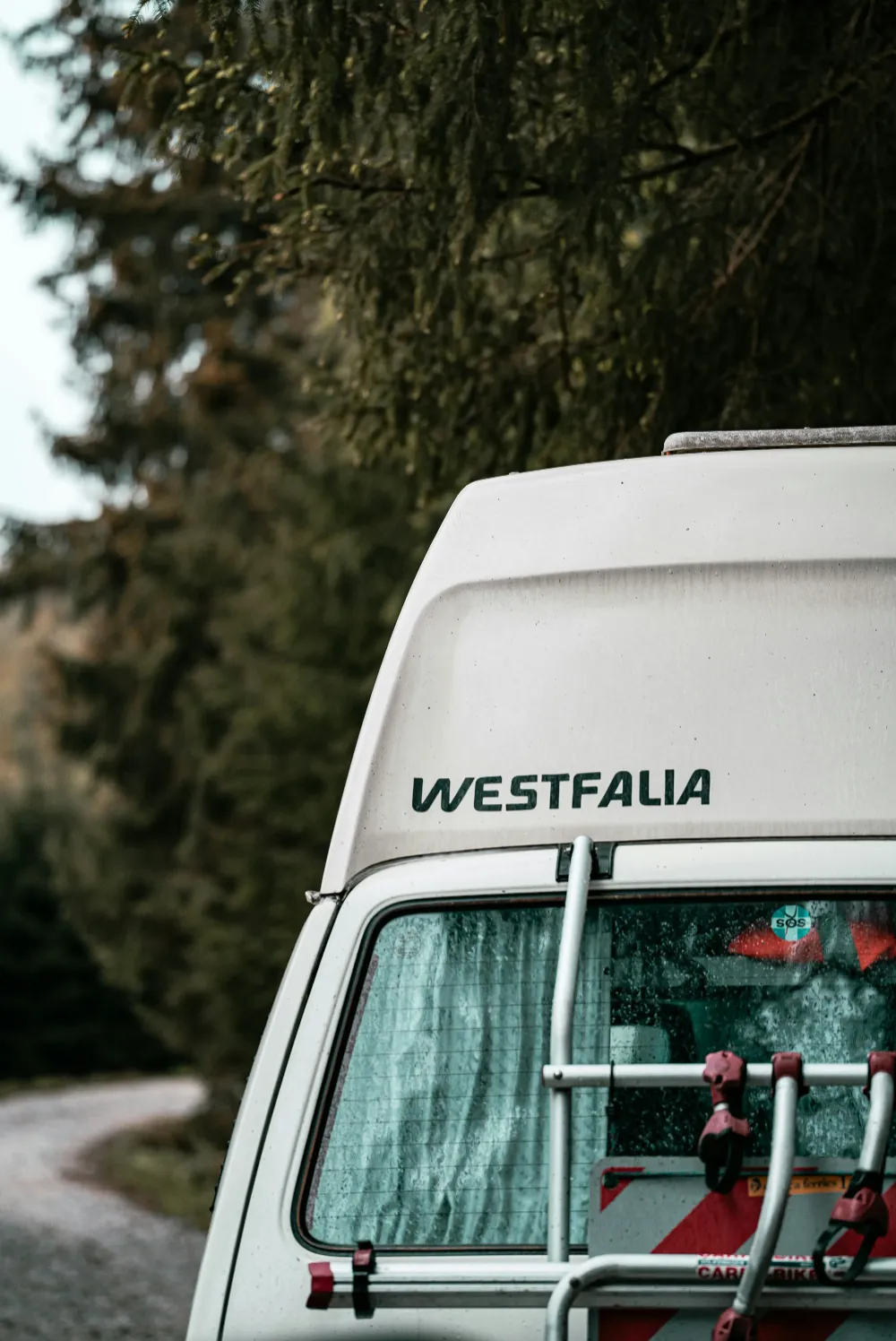 A man holding a cocktail in a dimly lit bar