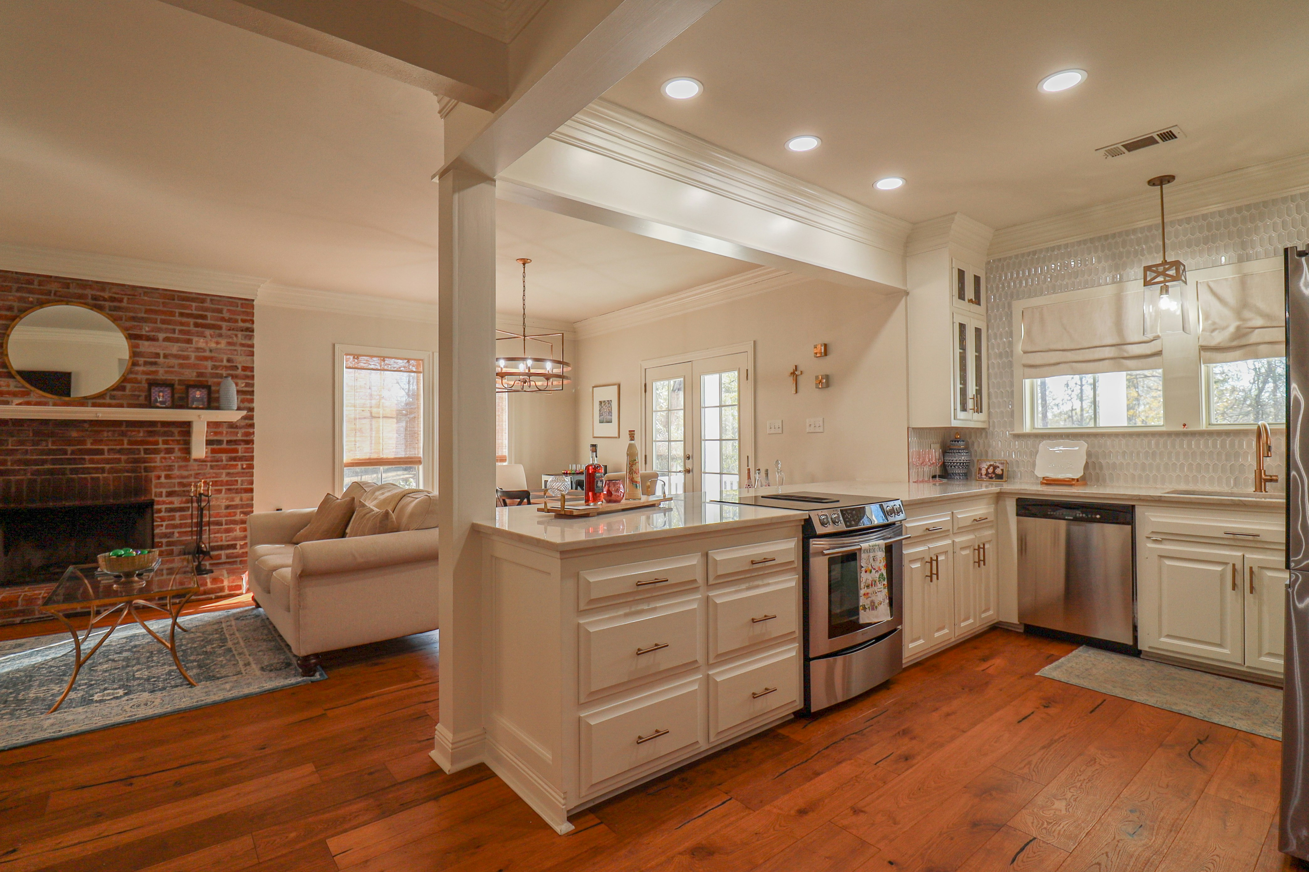 Modern kitchen with island and adjacent living room.
