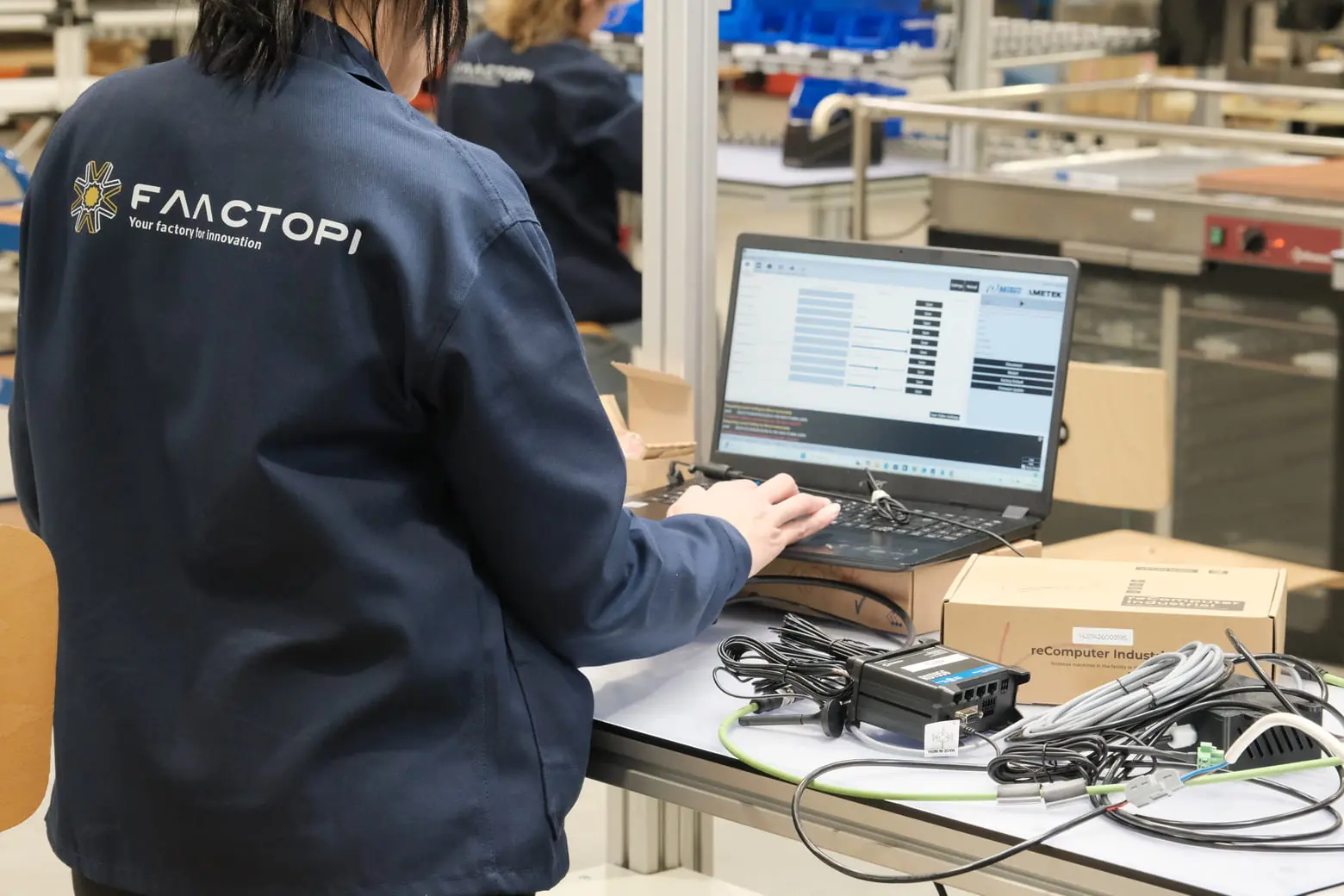 Operator working on a computer at a test station
