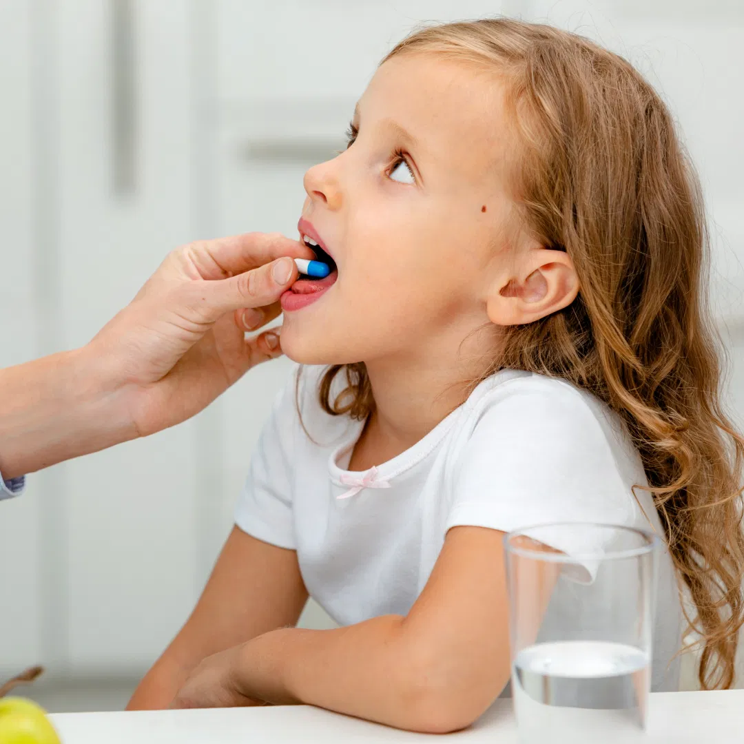 child taking antibiotics