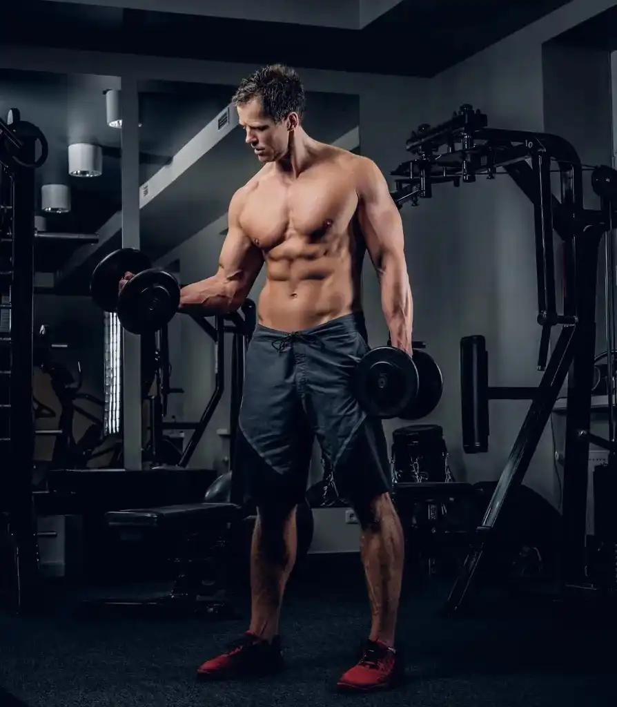 Athlete training with dumbbells in a Core USA equipped commercial gym"