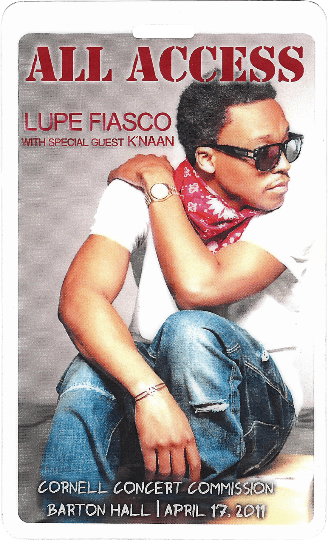 A backstage pass with a young man in sunglasses and a white shirt poses confidently, resting his arm on his knee. The background is vibrant.