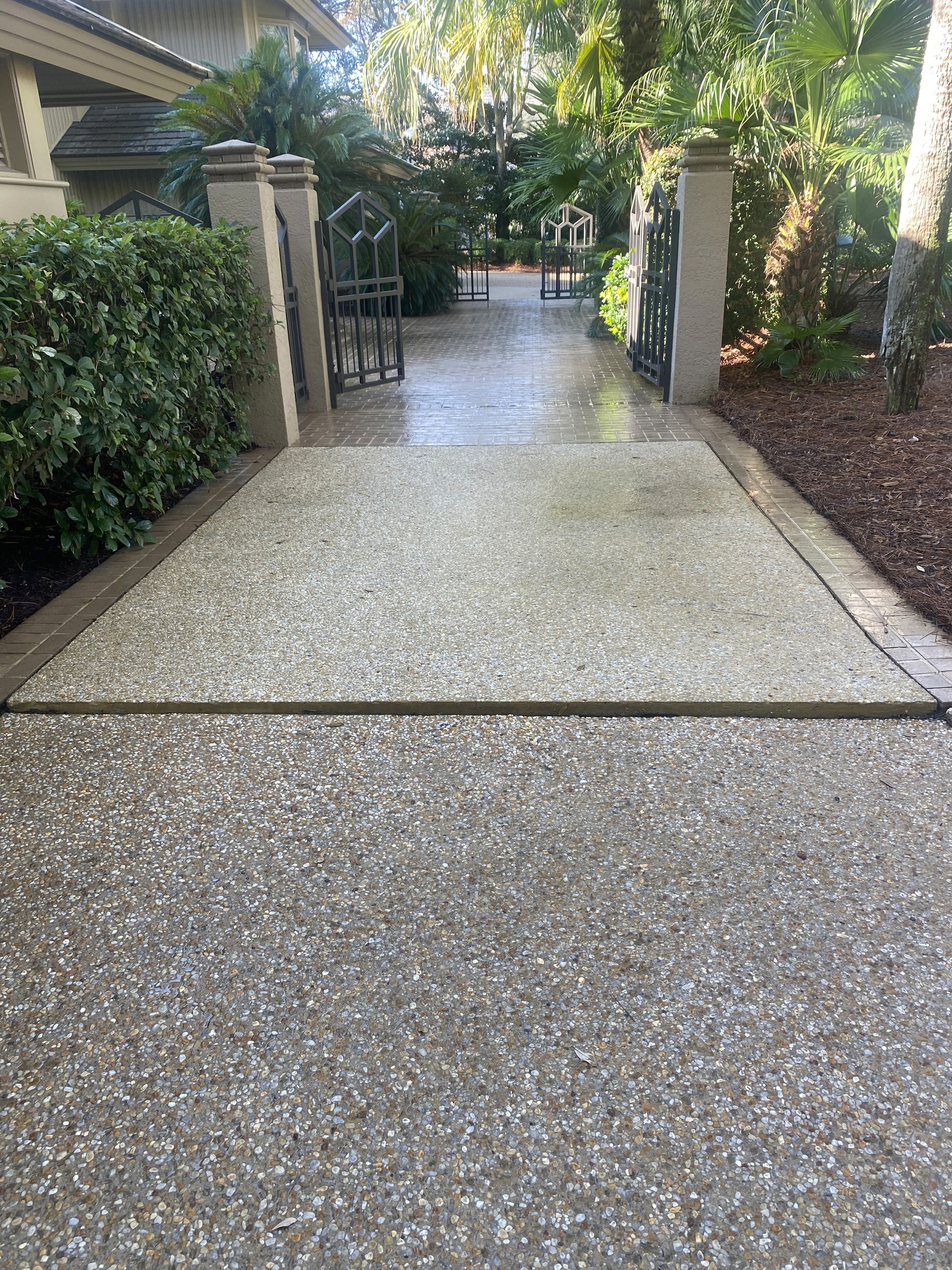 Before and after—driveway power washed in Hilton Head SC, showing restored clean concrete