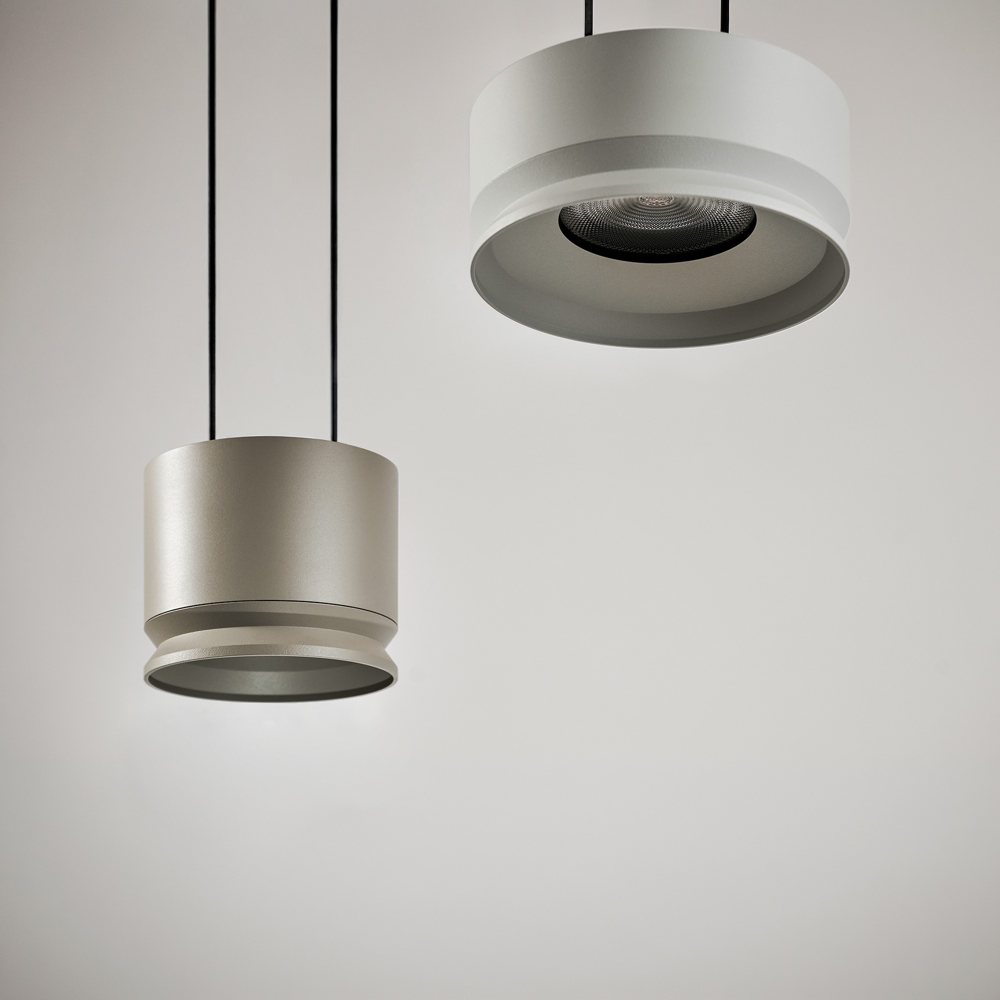 Two different sizes of grey Bistra Suspension light, details view from below.