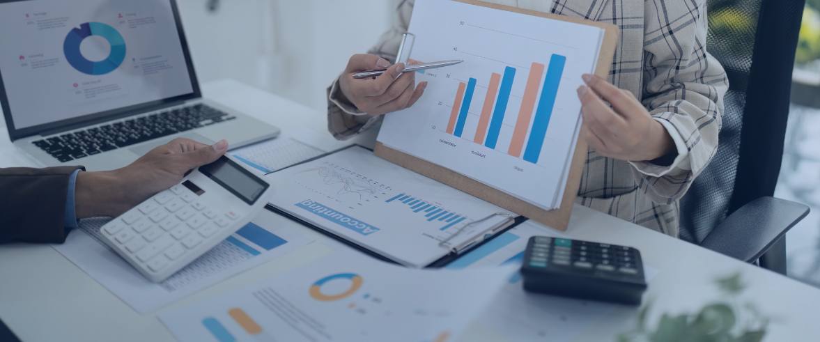 2 people sitting on chair near window during sunset