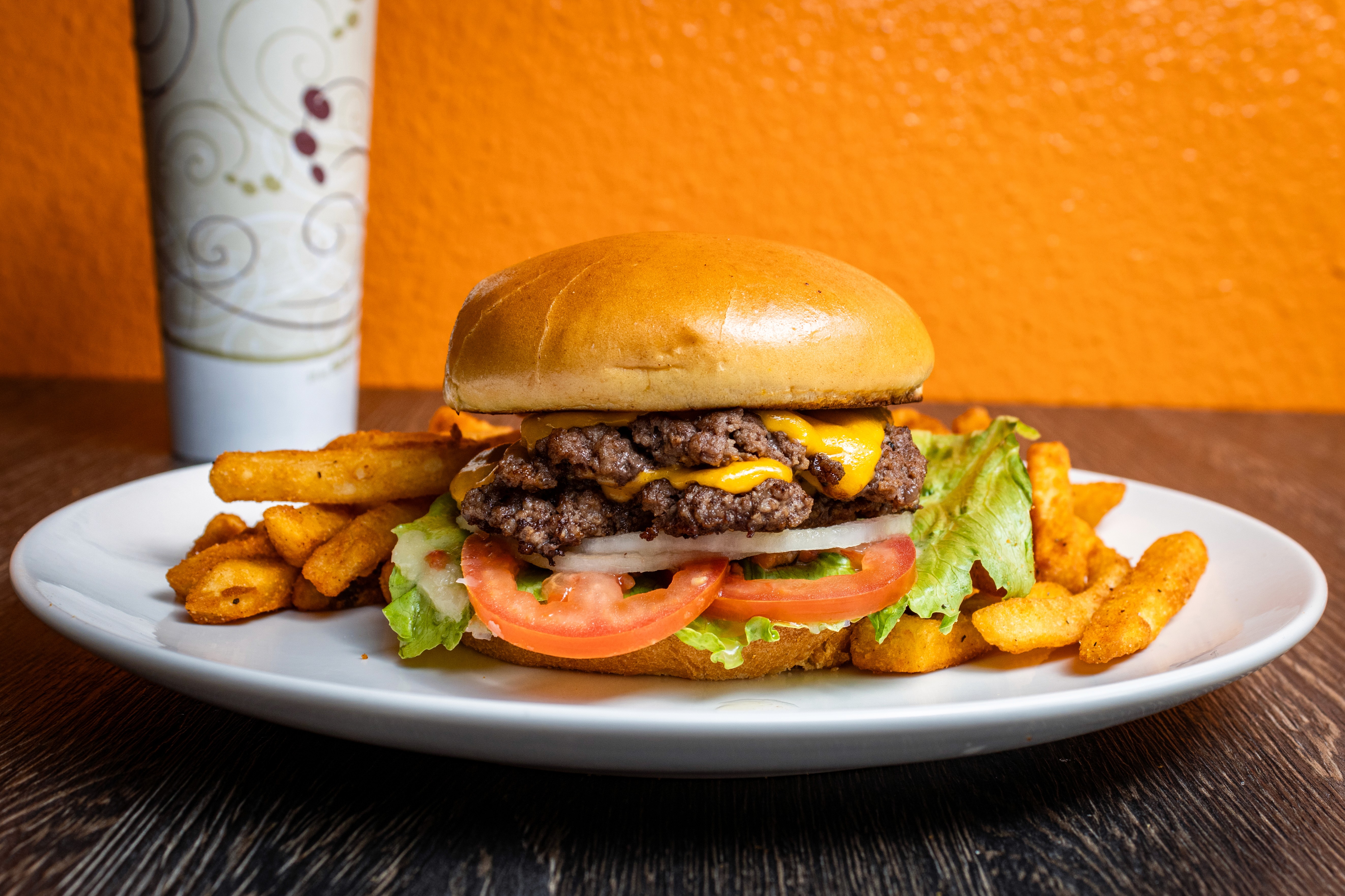 two glass of iced tea with some orange fruit around them