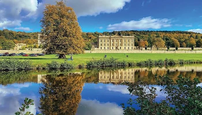 a view acroos the river to chatsworth house derbyshire. Filming location for pride and prejudice and popular tour location in derbyshire england