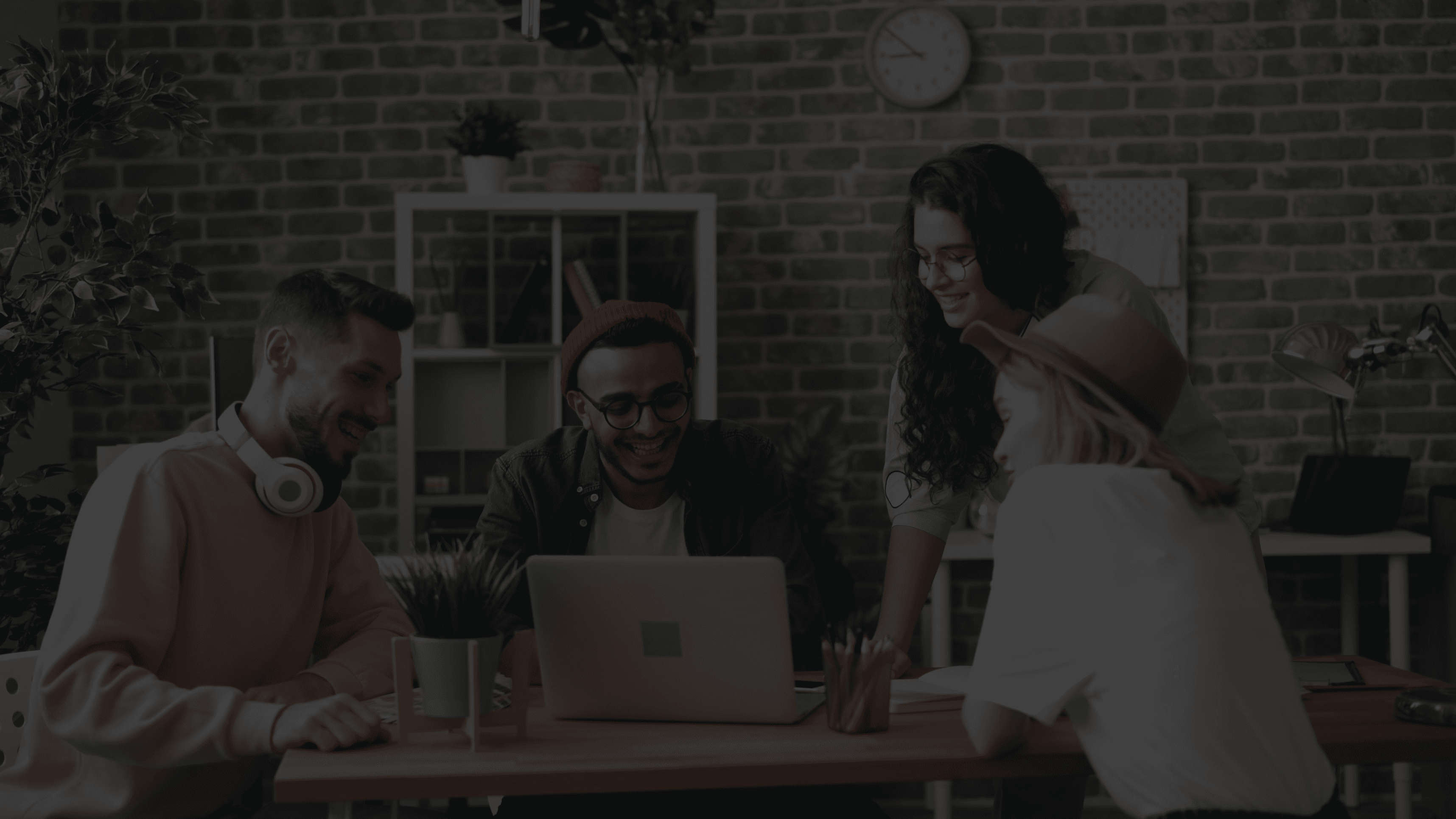 photo of three men jumping on ground near bare trees during daytime