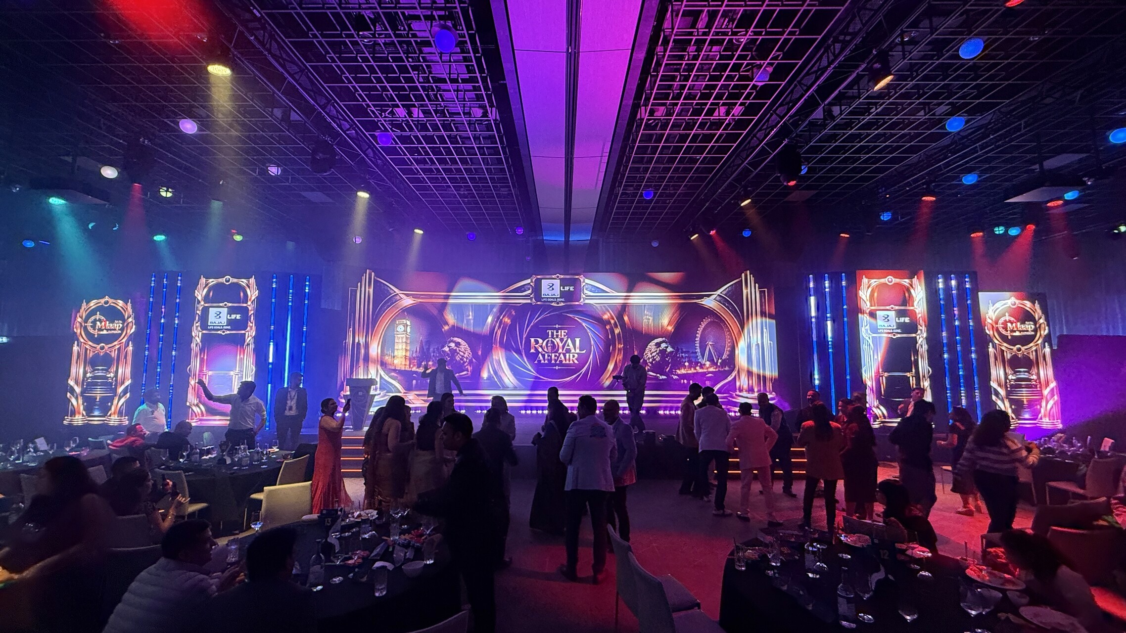 Bajaj Life gala stage with a central LED wall, four LED totems and colourful lighting above guests on the dance floor.
