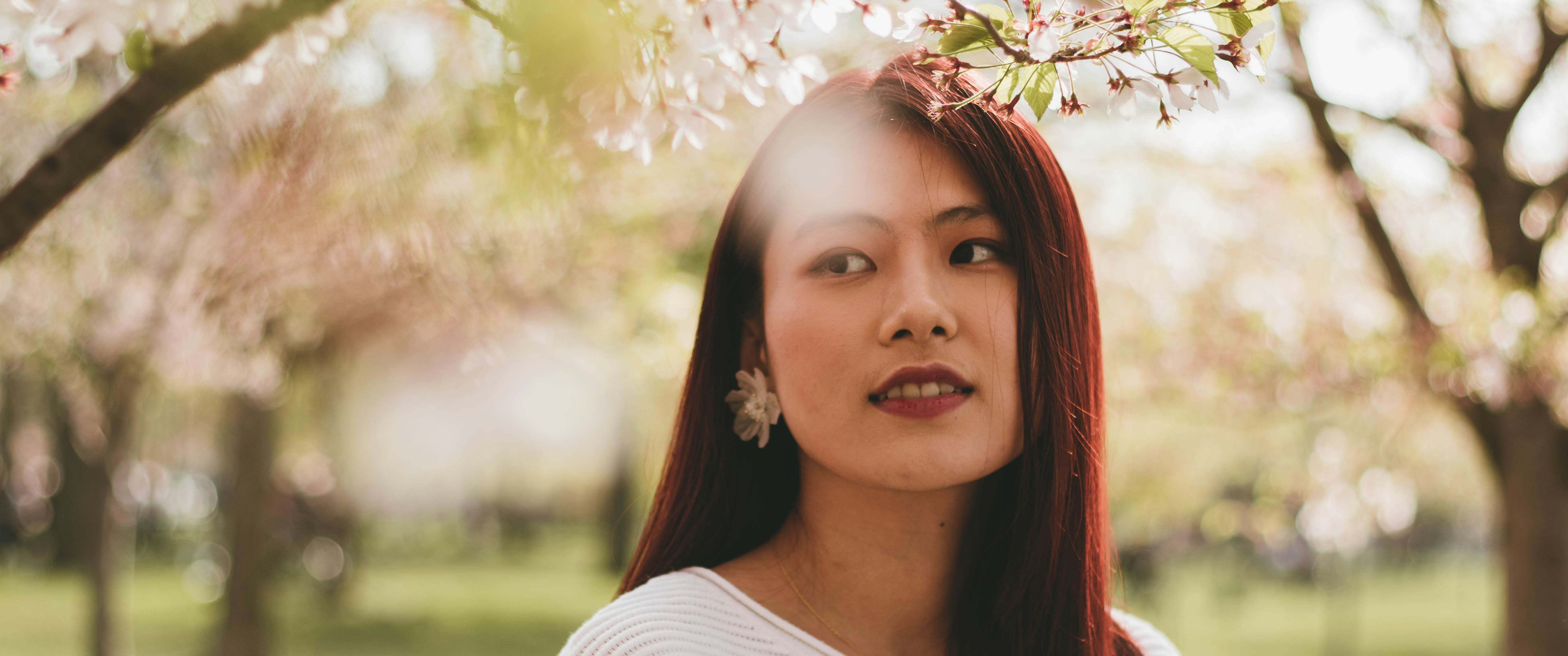 smiling woman under trees