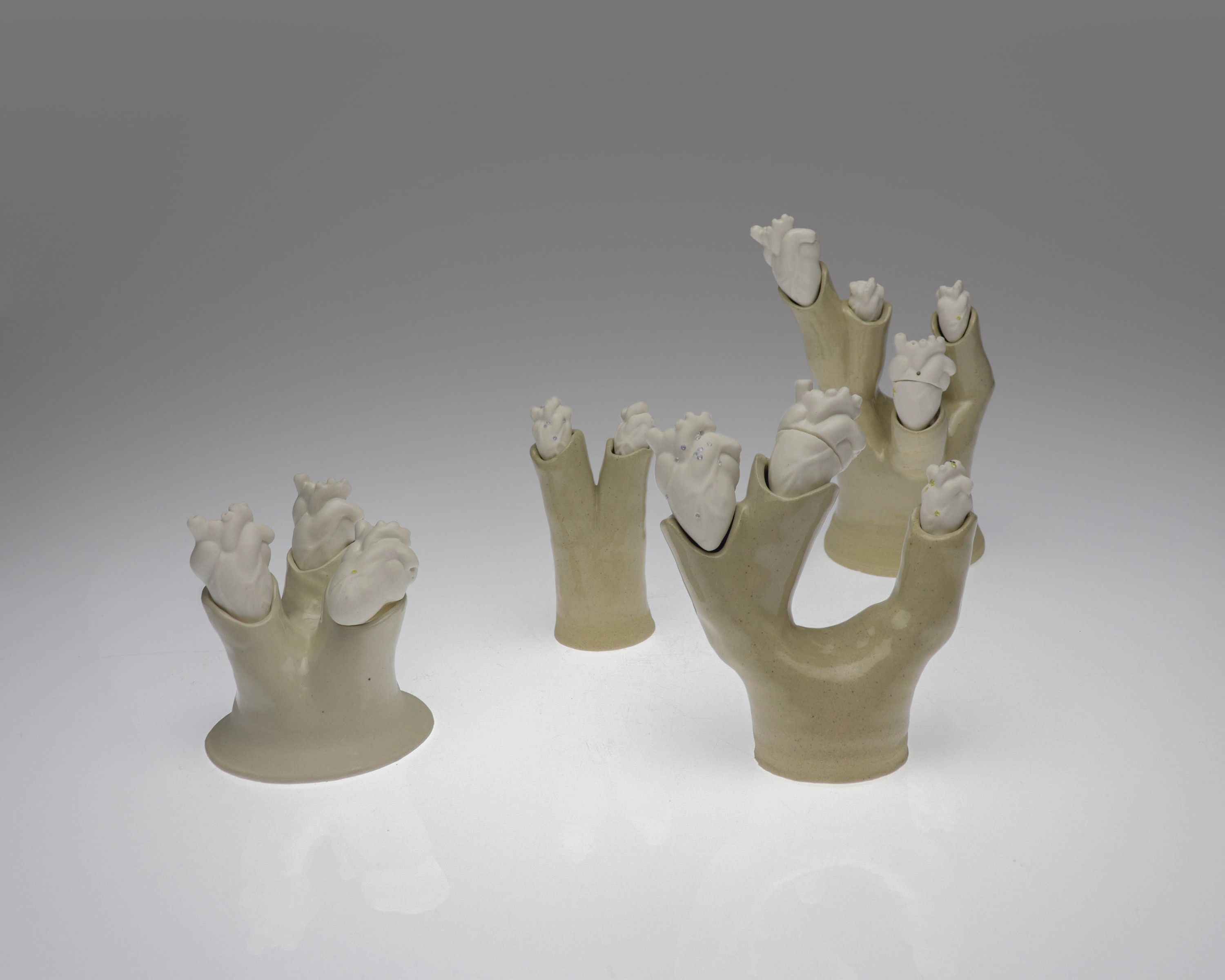 Individual view of a unique ceramic heart from Perfect Imperfection series by Yuxin Song. Highlighting cracks with cubic zirconia and mica powder. Light-up sculpture made with resin, 2022.