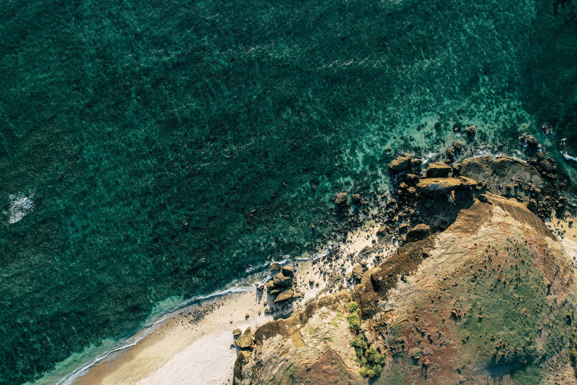 Aerial view of Lombok's rocky coastline and clear turquoise water