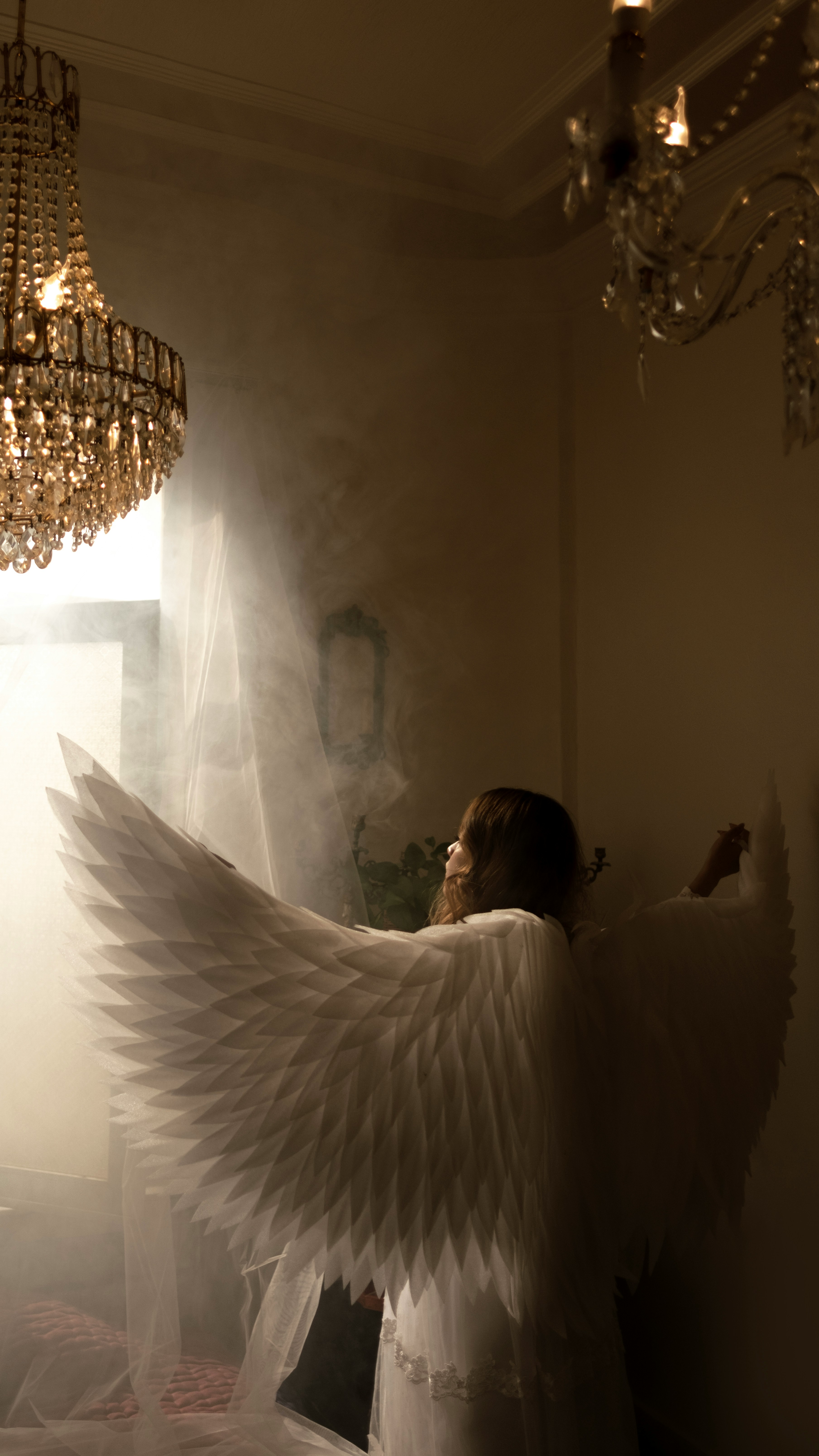 A woman in a white dress with angel wings