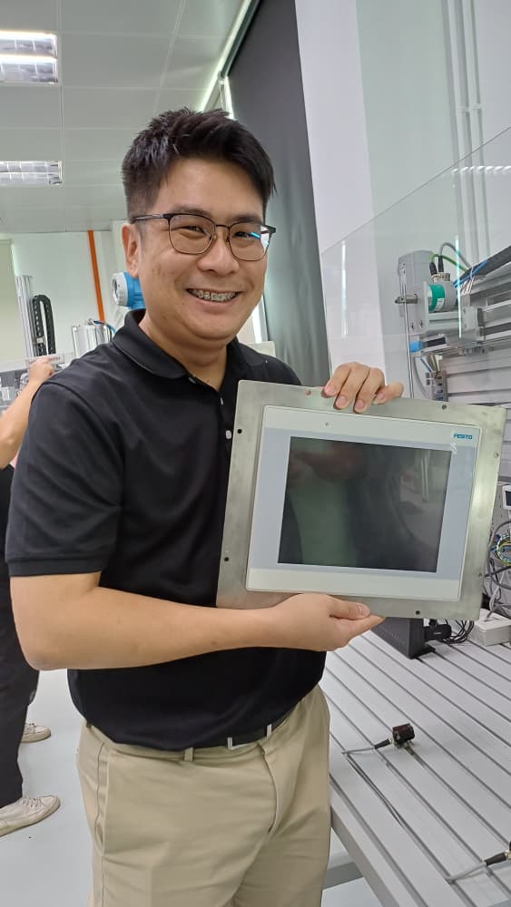 Close-up of EtherCAT communication modules and industrial networking being taught during the automation training.